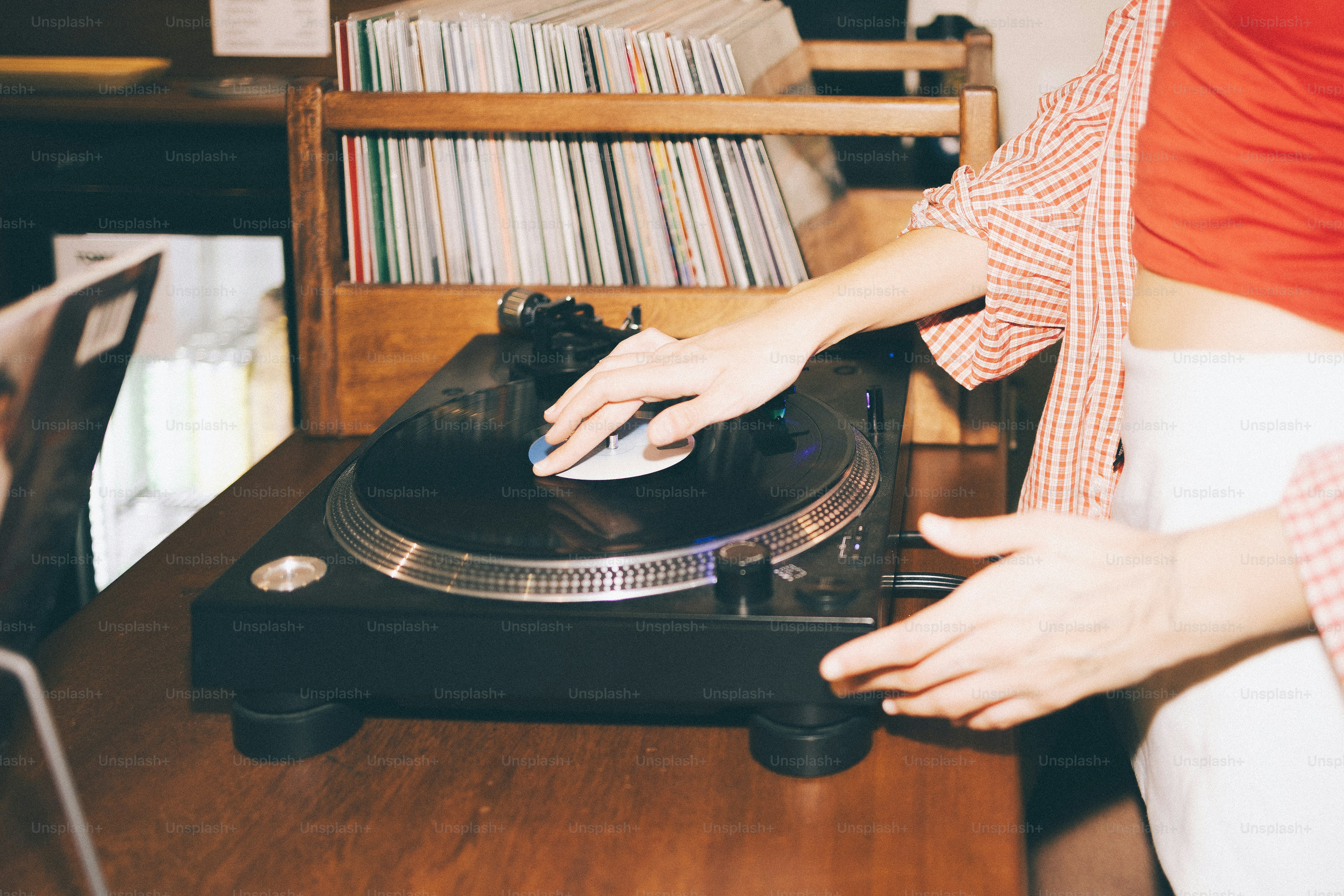 Person playing vinyl record on turntable