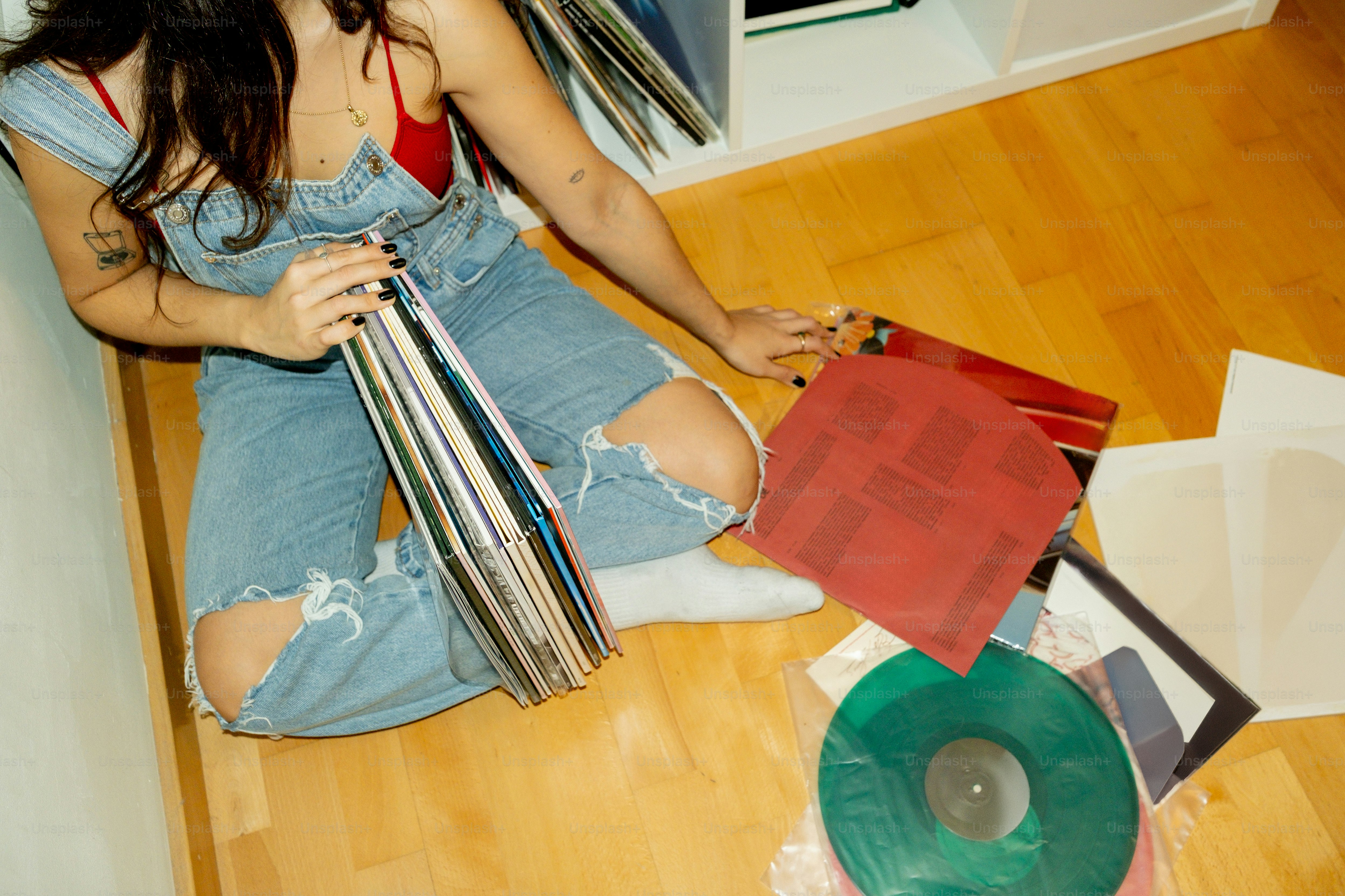 Woman sitting on floor with vinyl records