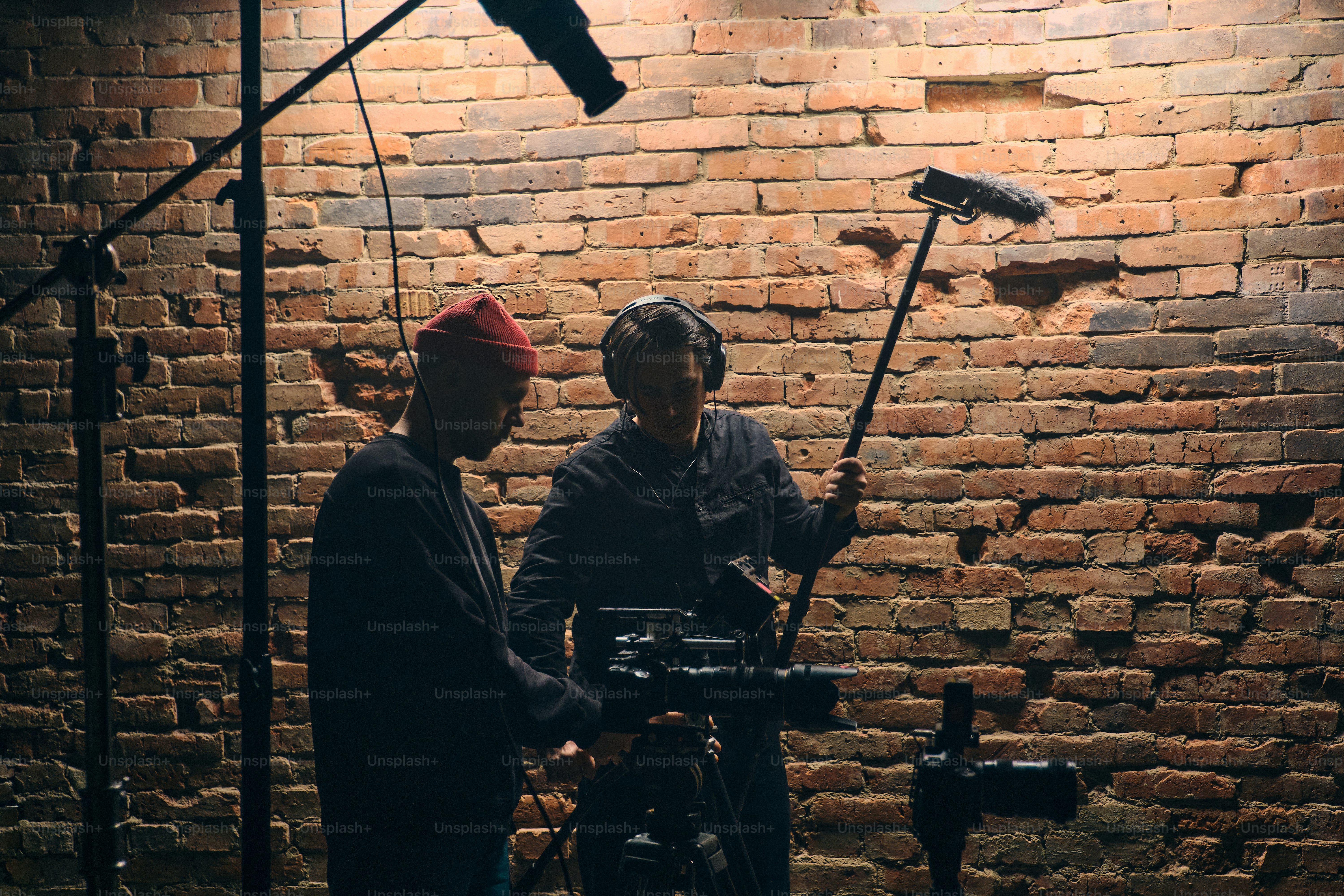 Filming crew setting up equipment in studio photo – Camera Image on ...
