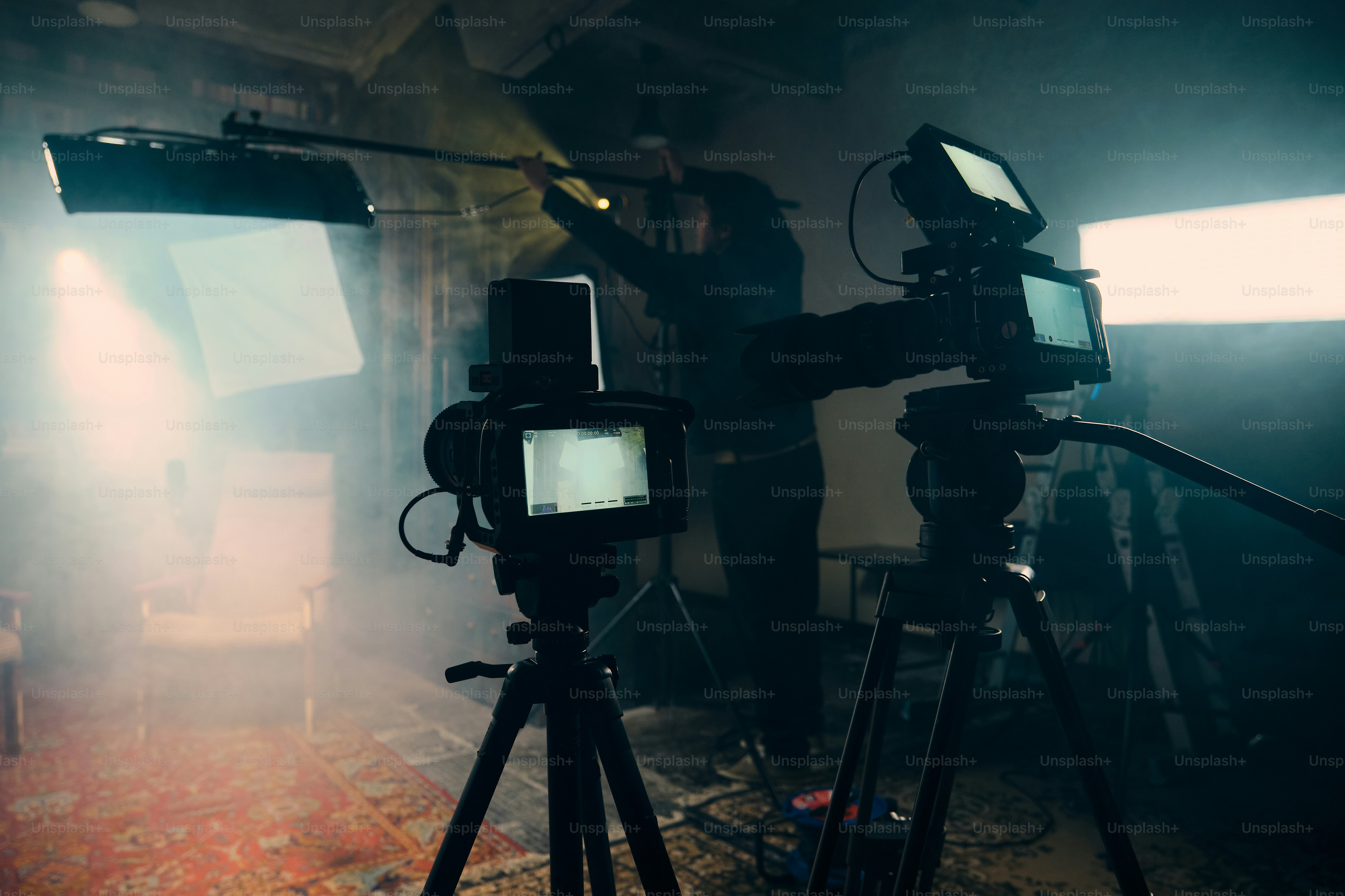 Filming crew setting up equipment in studio photo – Camera Image on ...