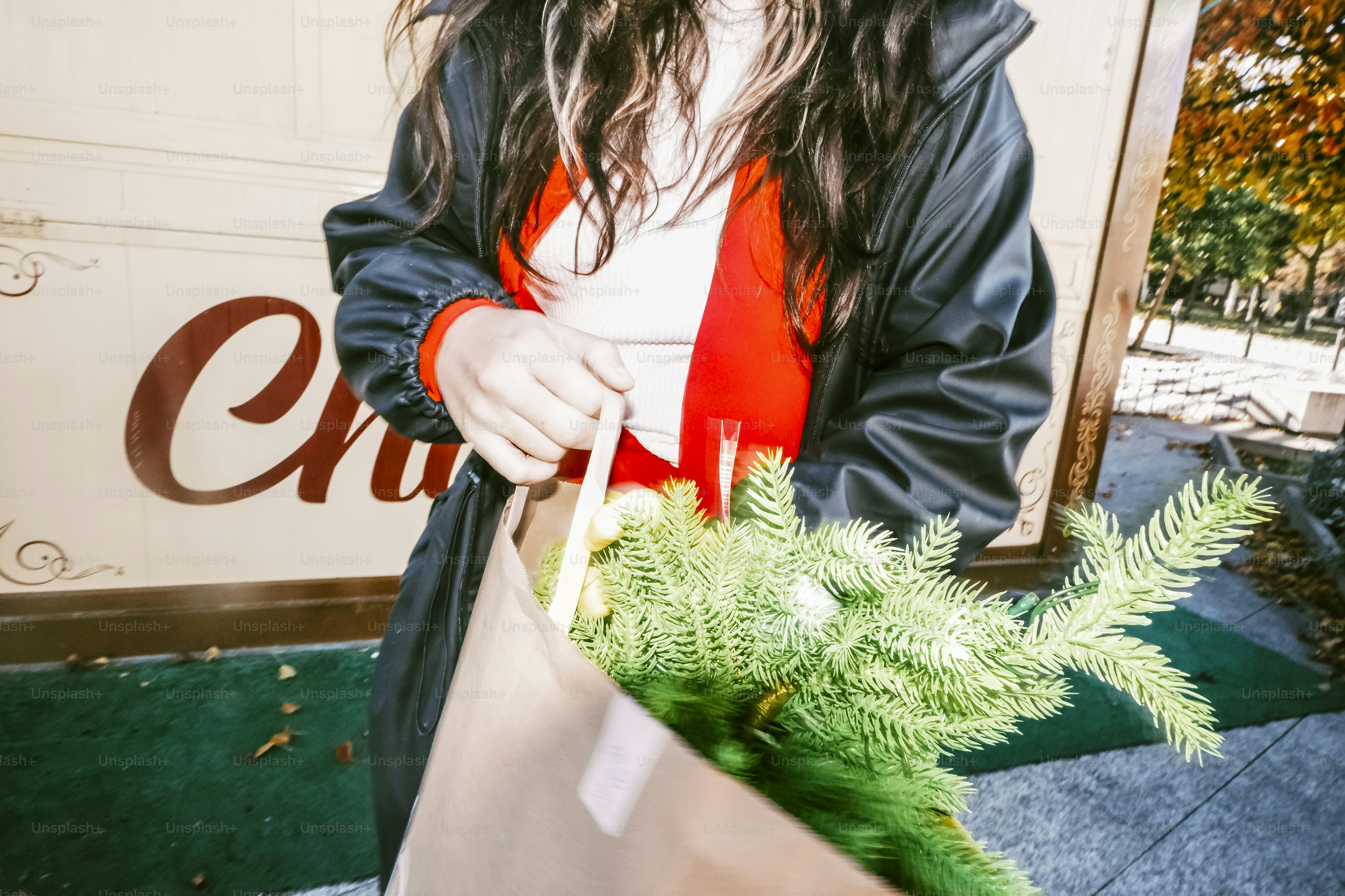 Woman holding a bag with pine branches