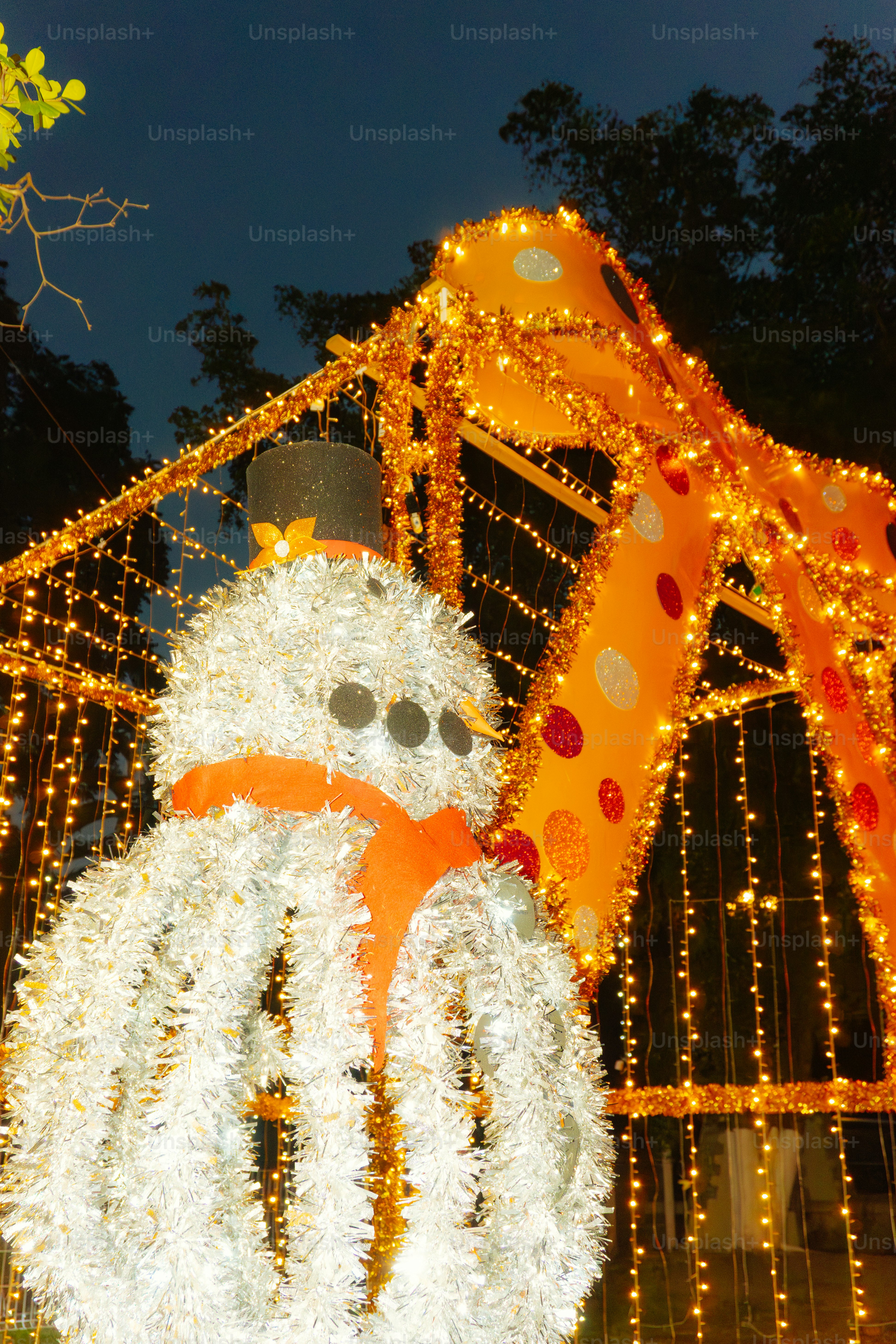 A festive snowman decoration with bright orange lights