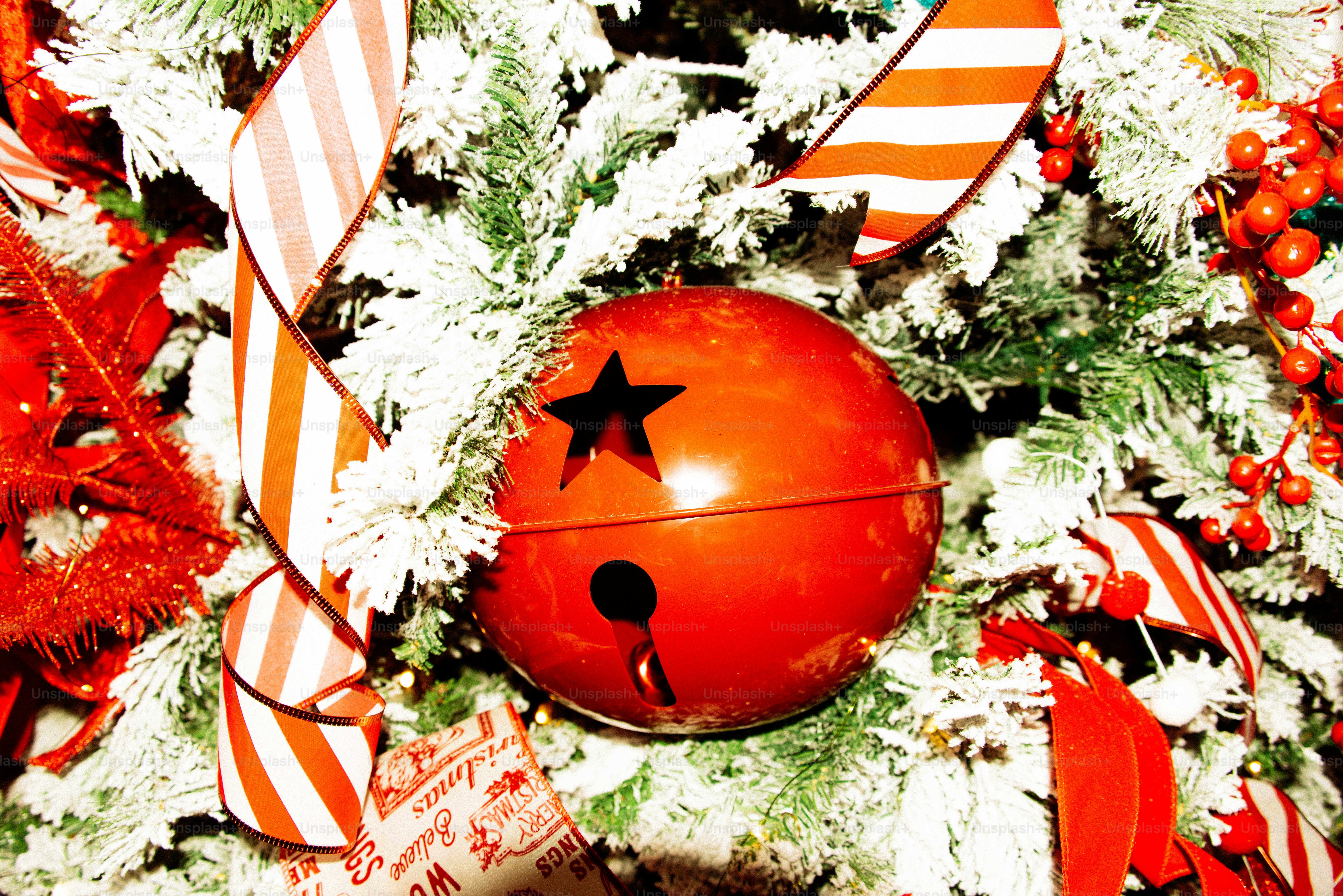 Enfeite de sino de Natal vermelho na árvore de geada