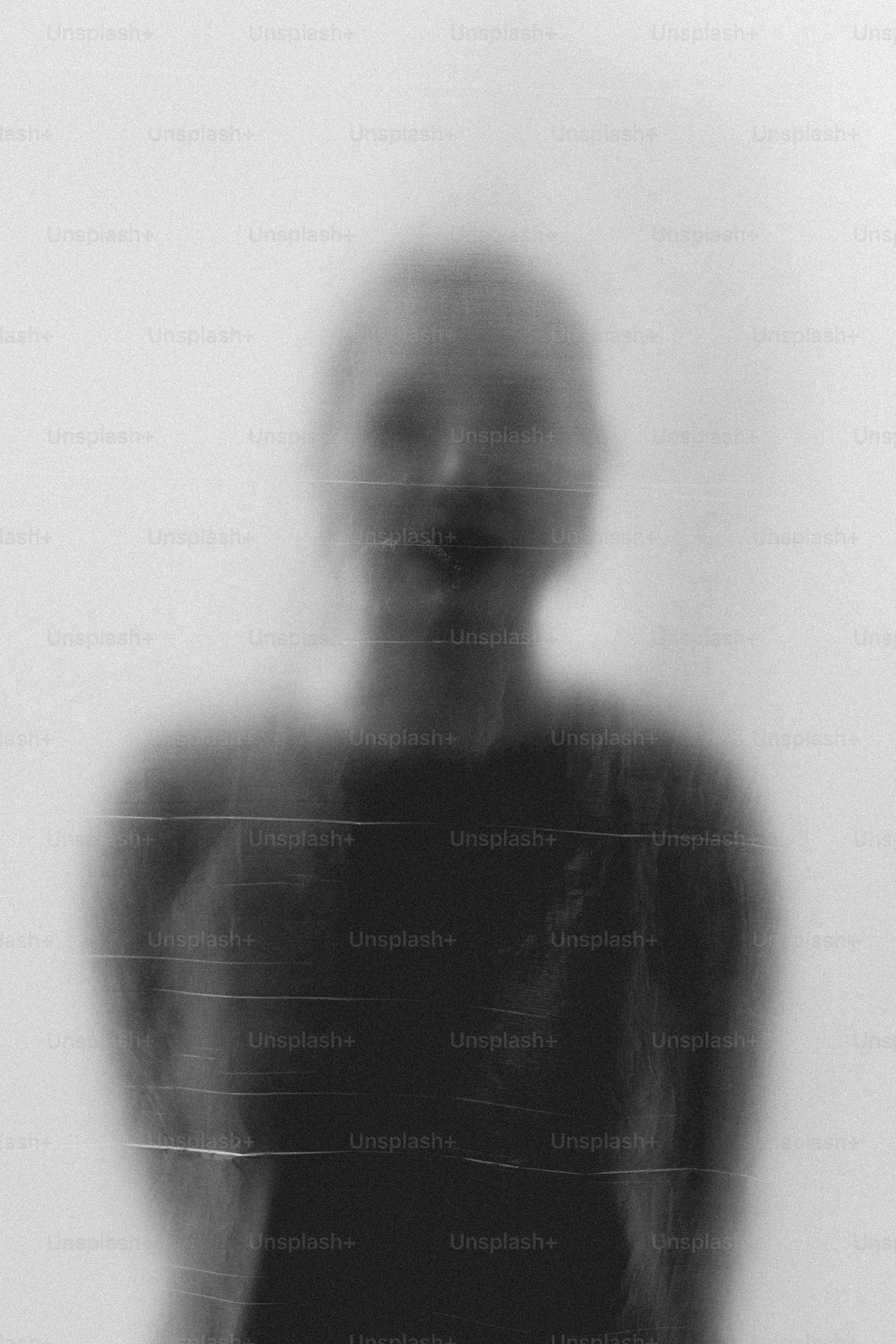 Blurred figure behind translucent material