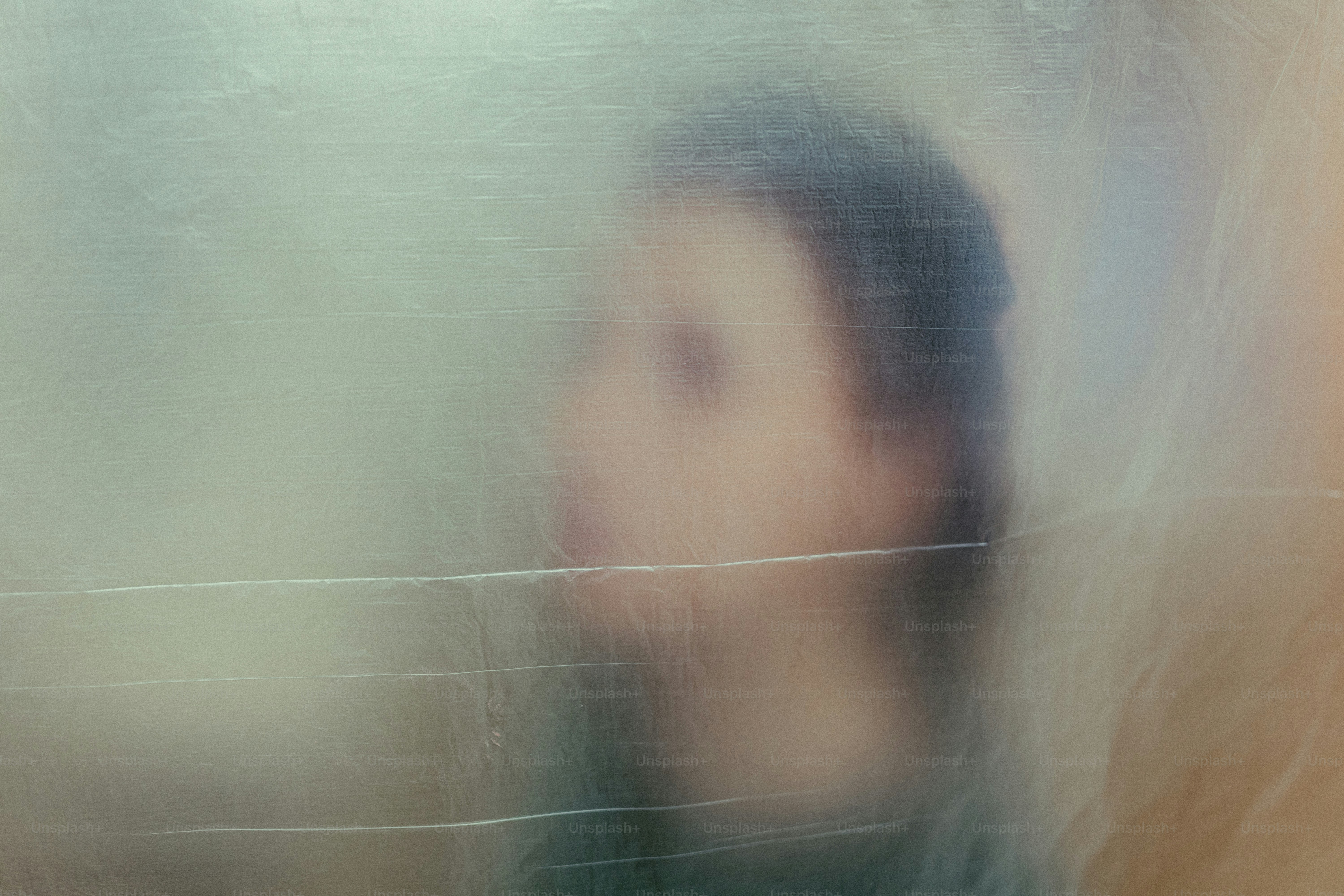 Blurred profile of a person seen through glass