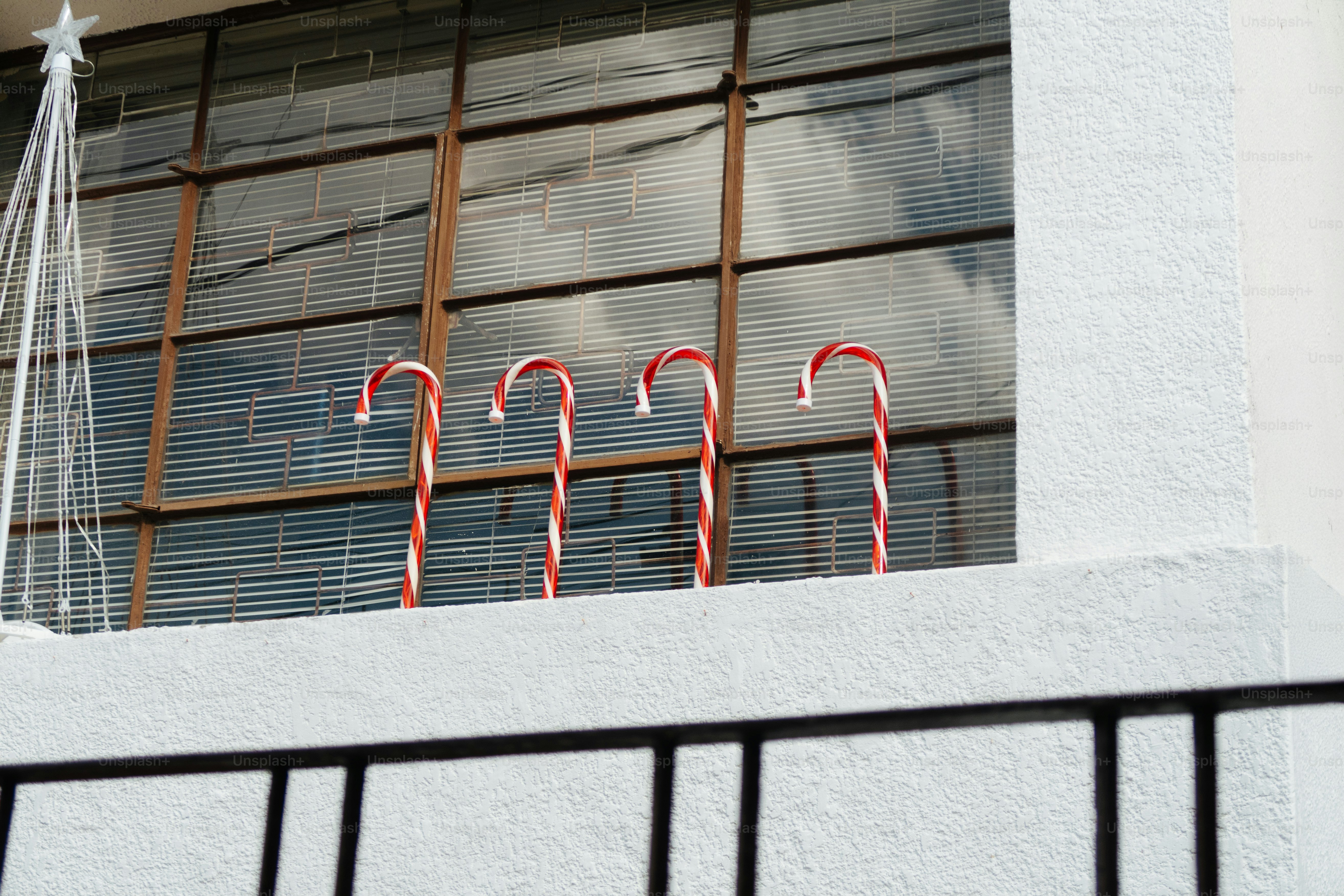 Four candy canes displayed on a ledge