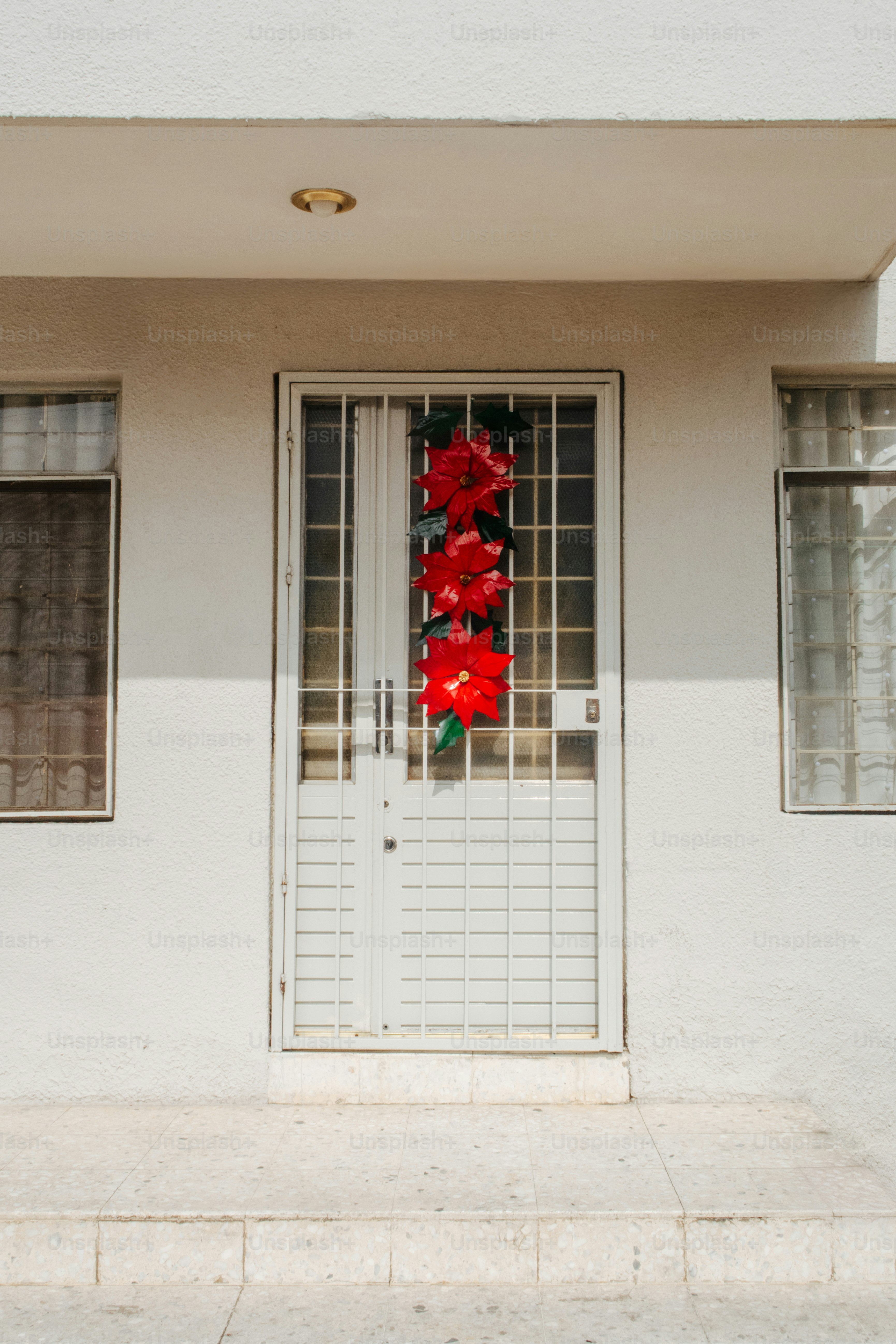 White door with red poinsettias and security bars