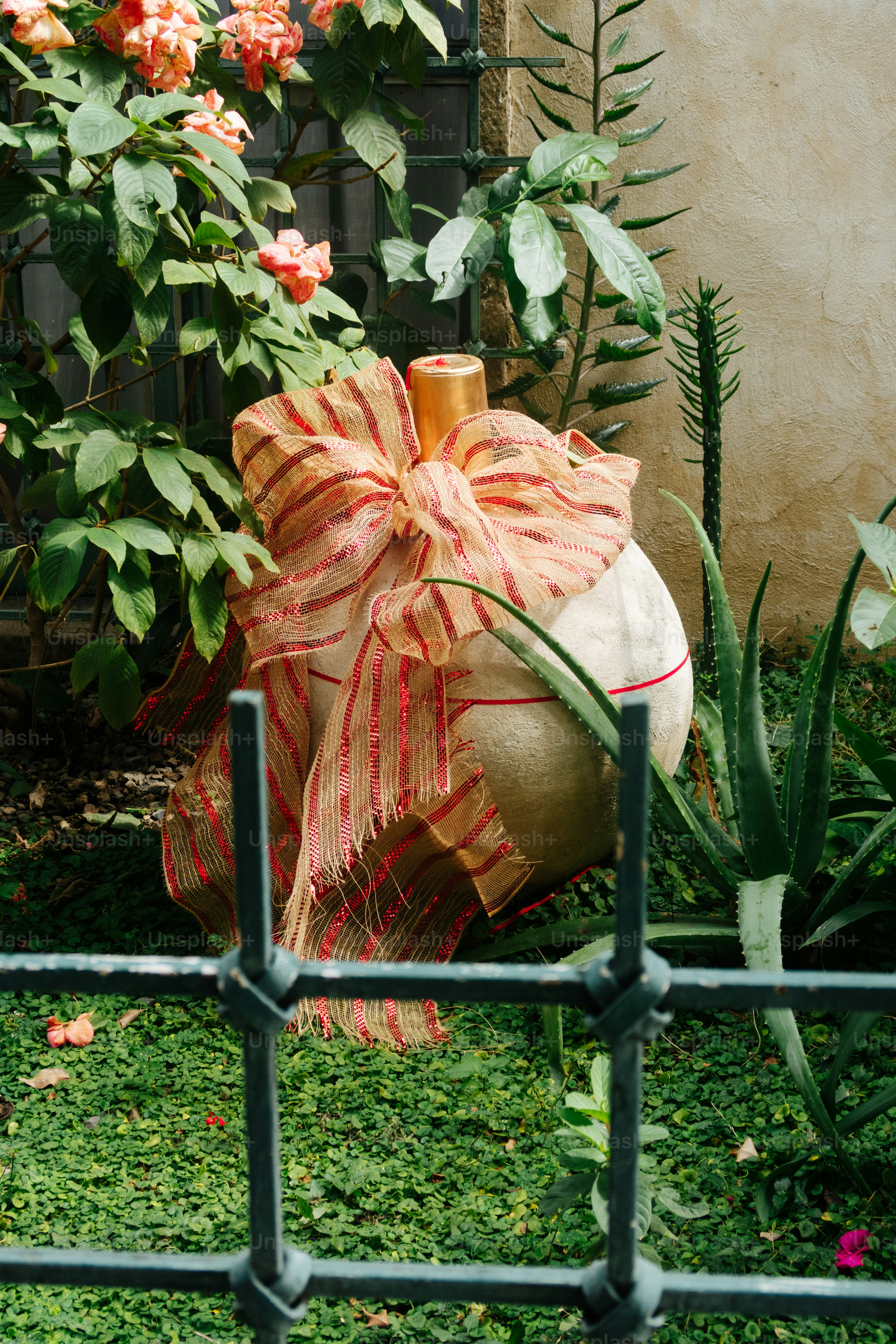Large decorative ball with ribbon in garden