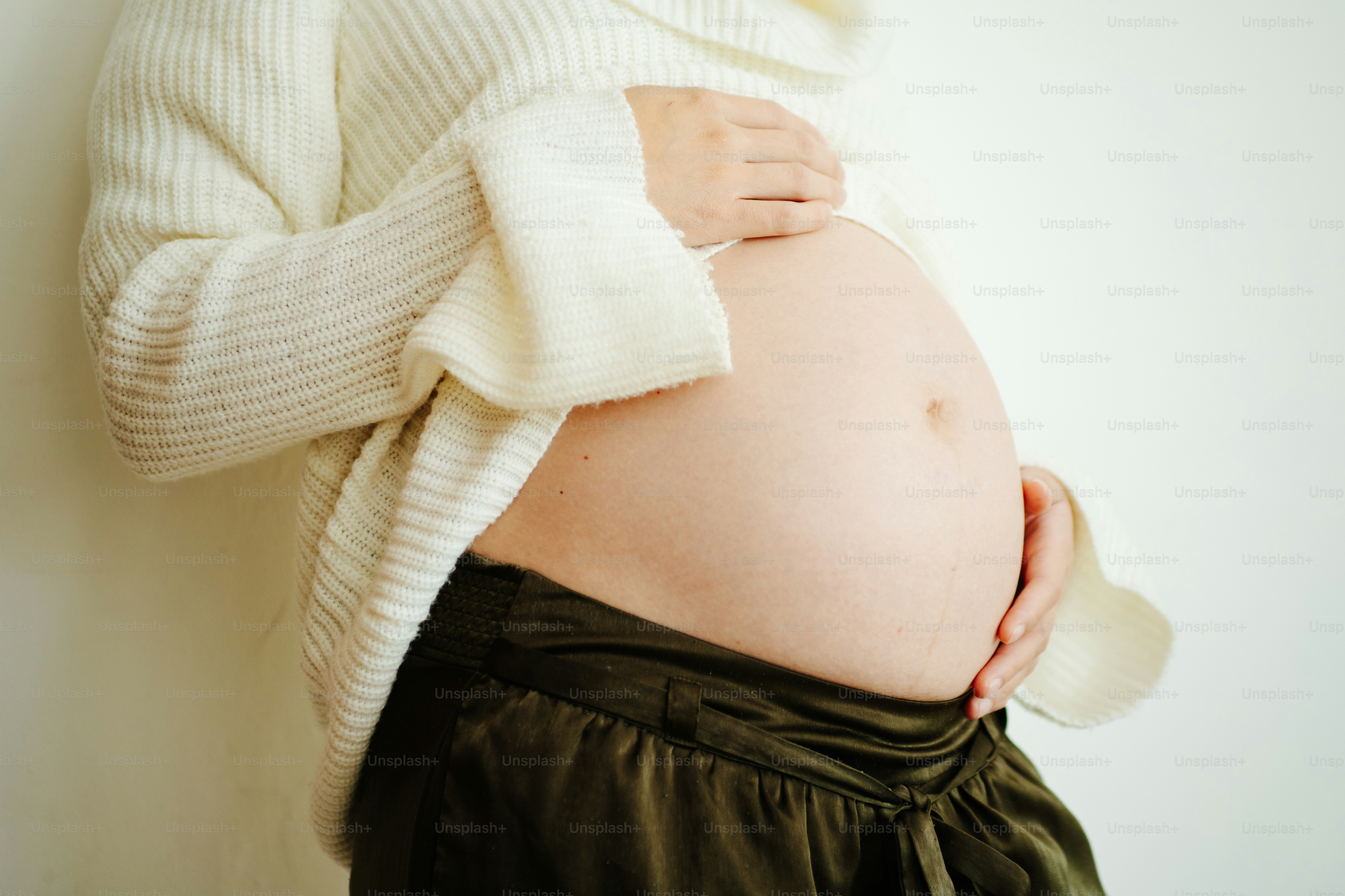 Pregnant woman holding her belly