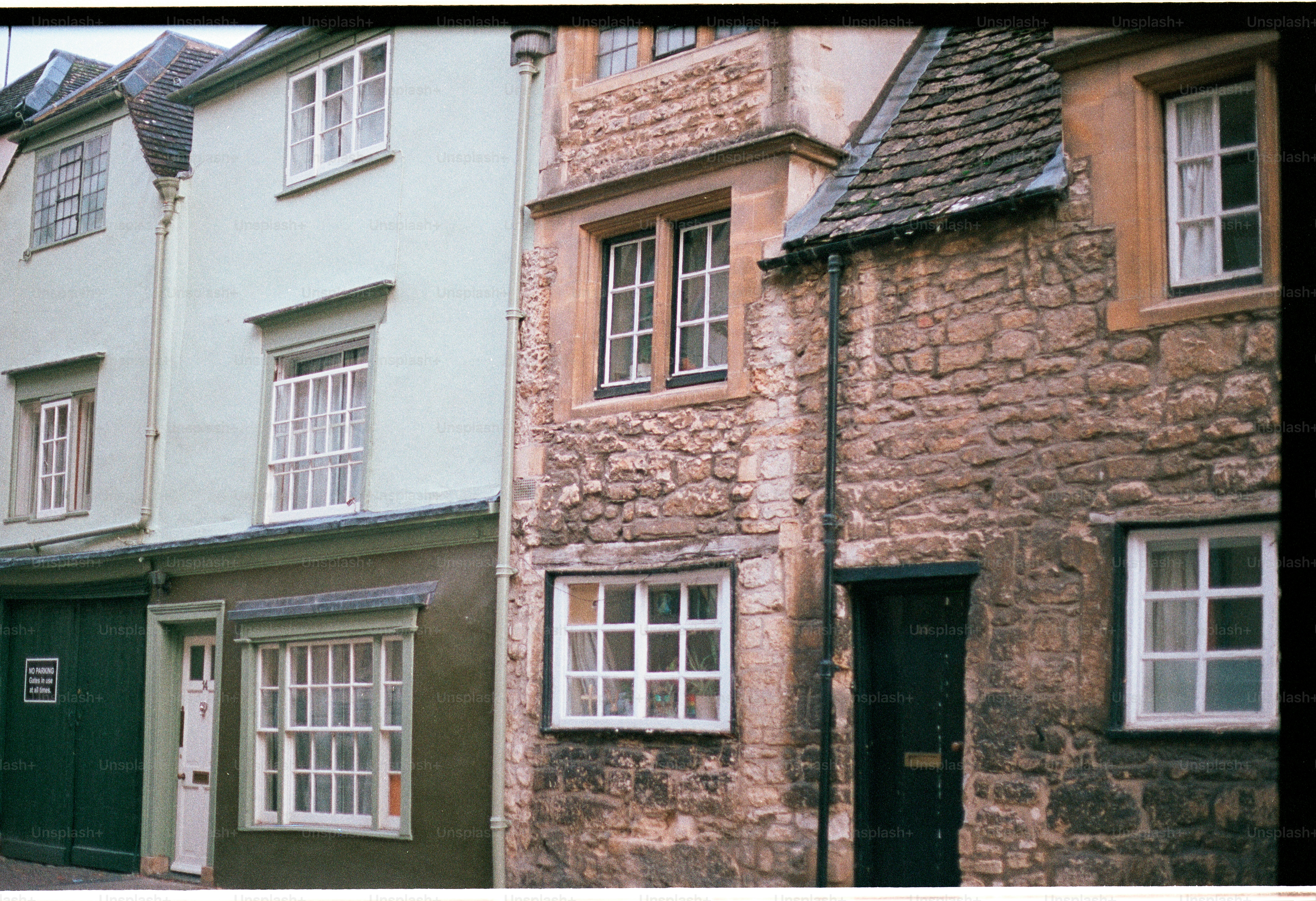 Row of historic buildings with stone and pastel facades.