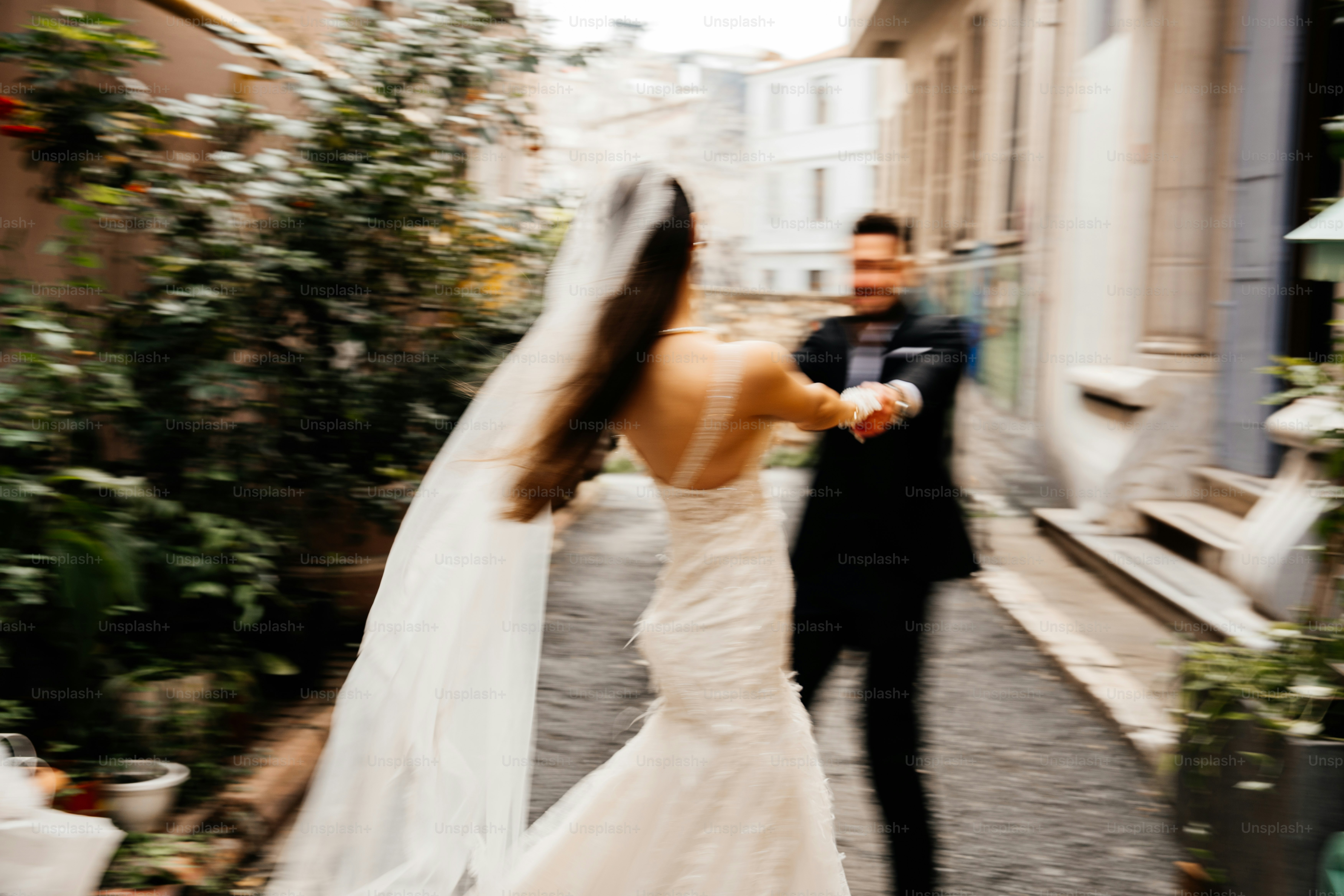 Bride and groom dancing in a narrow street.