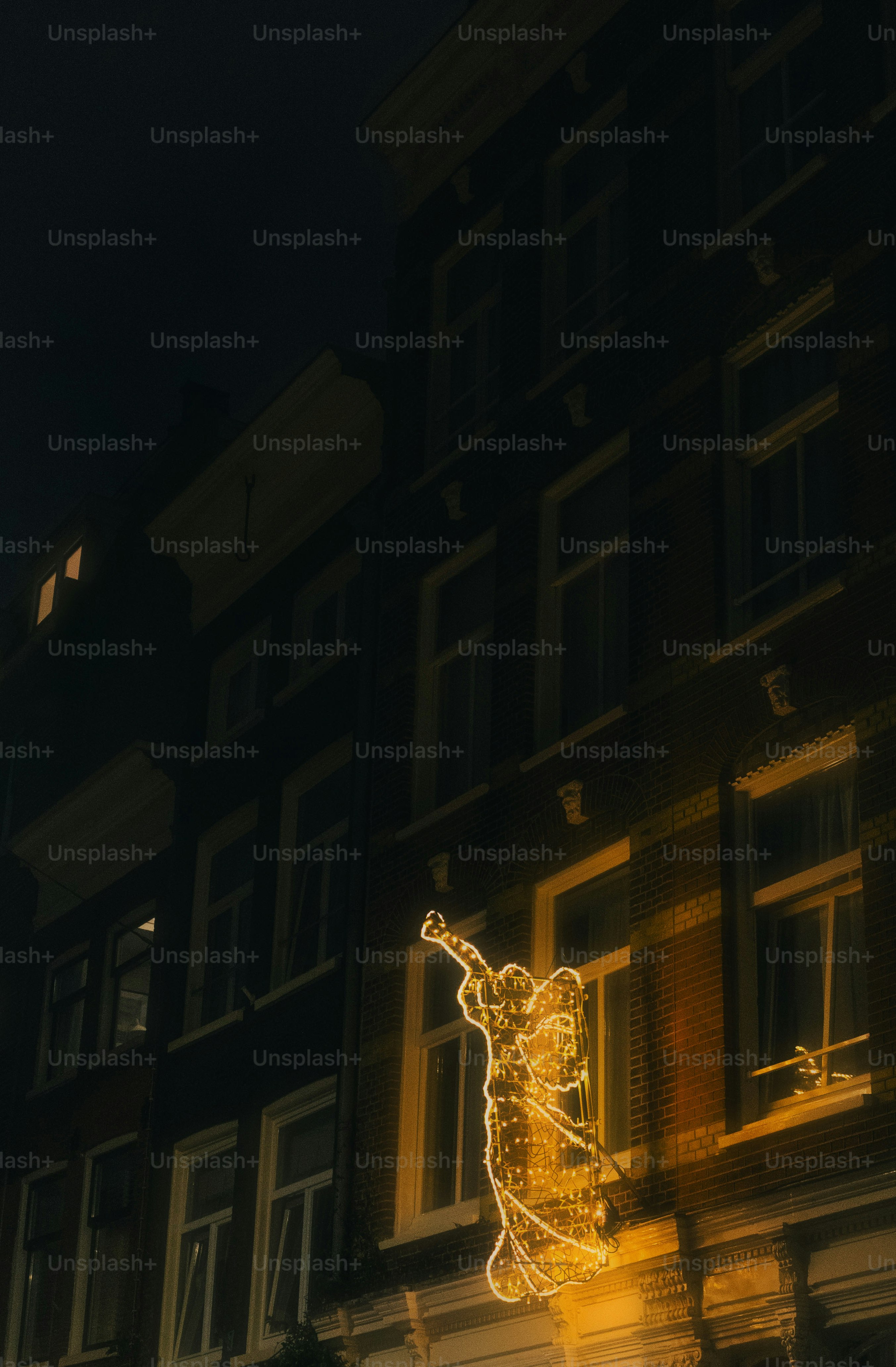 Building facade with glowing angel decoration at night