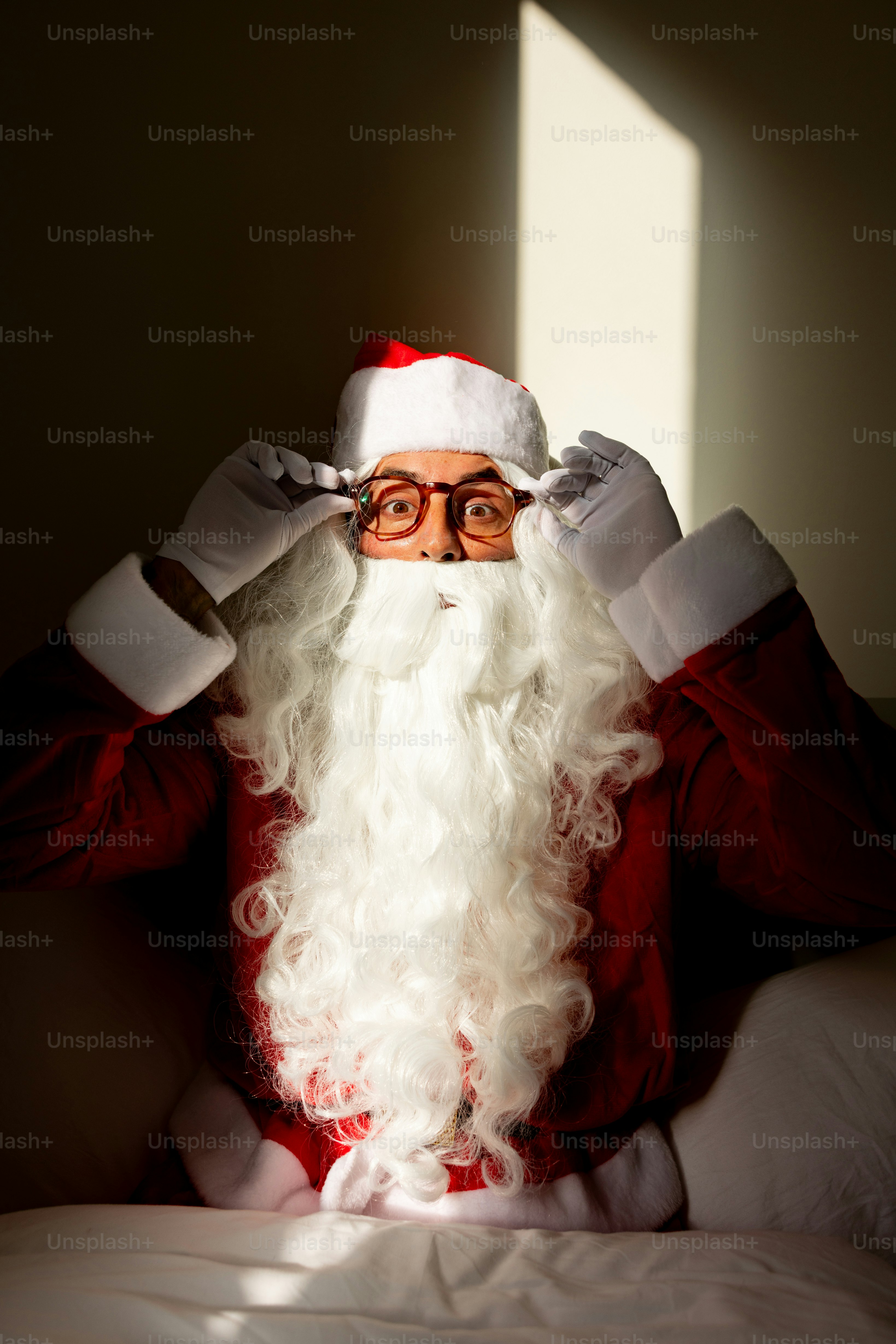 Santa claus adjusting his glasses with white gloves