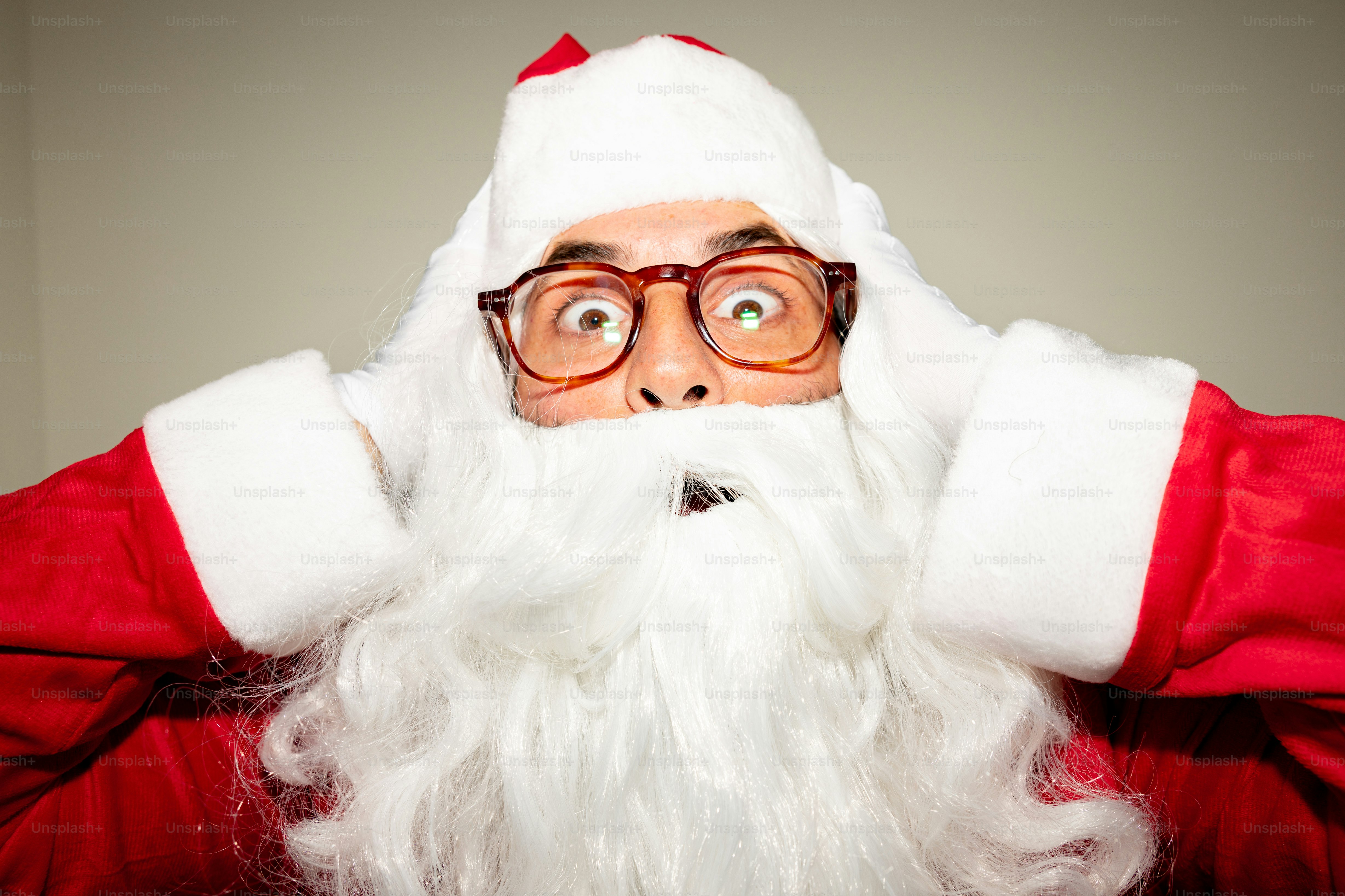 Man in santa costume with hands on head