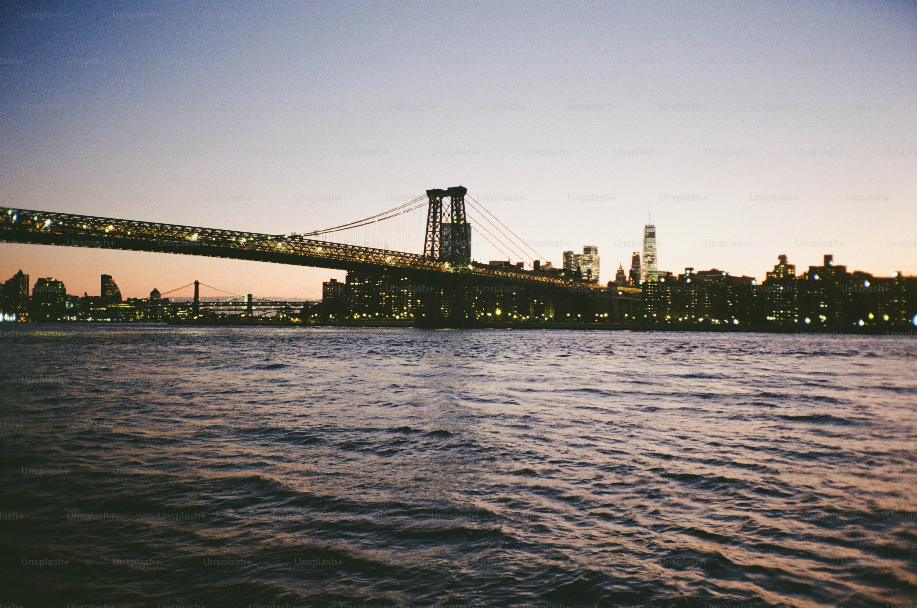 Cityscape with bridge over water at dusk photo – Wallpaper Image on ...