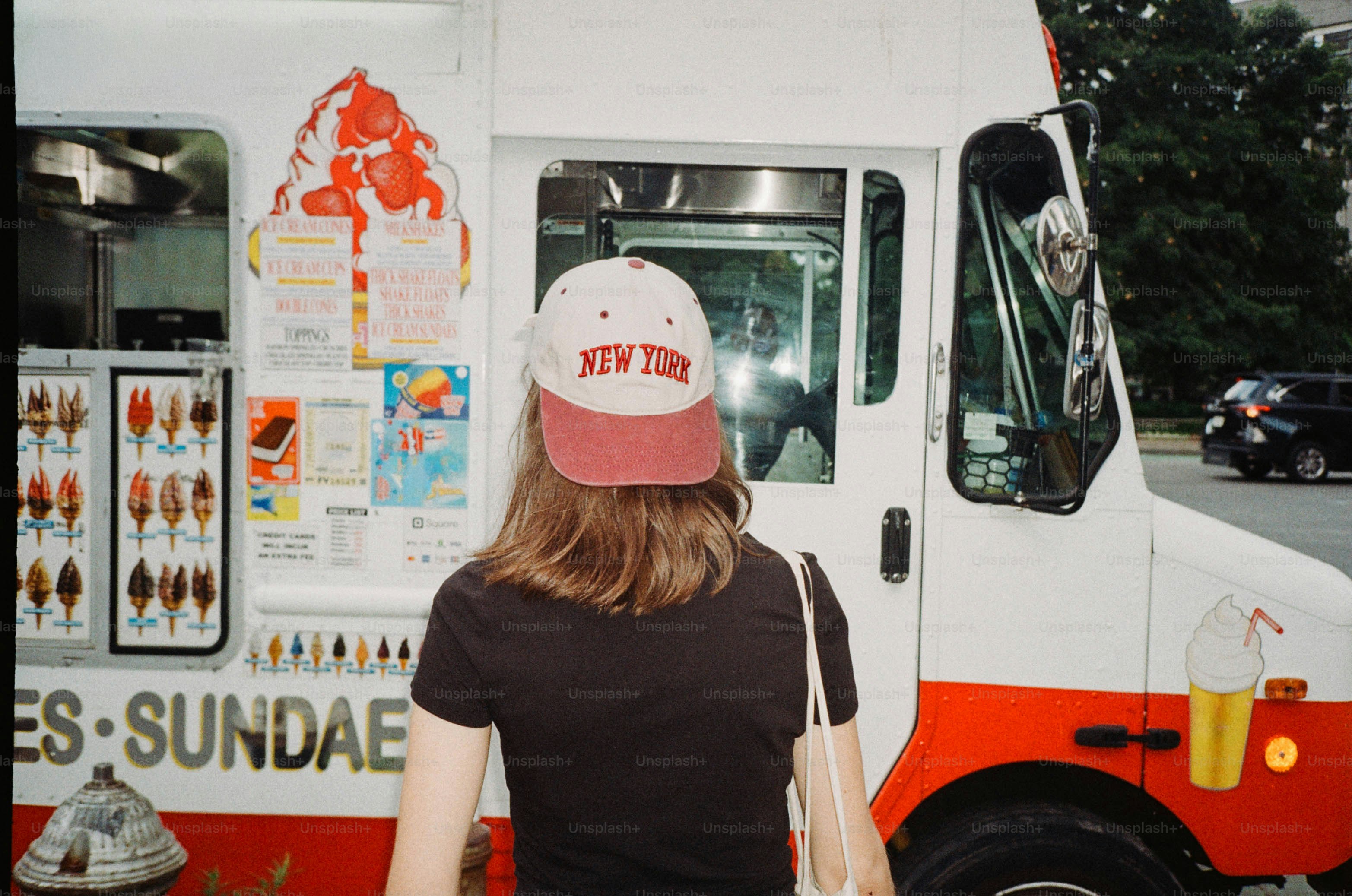 Woman in new york hat approaches ice cream truck