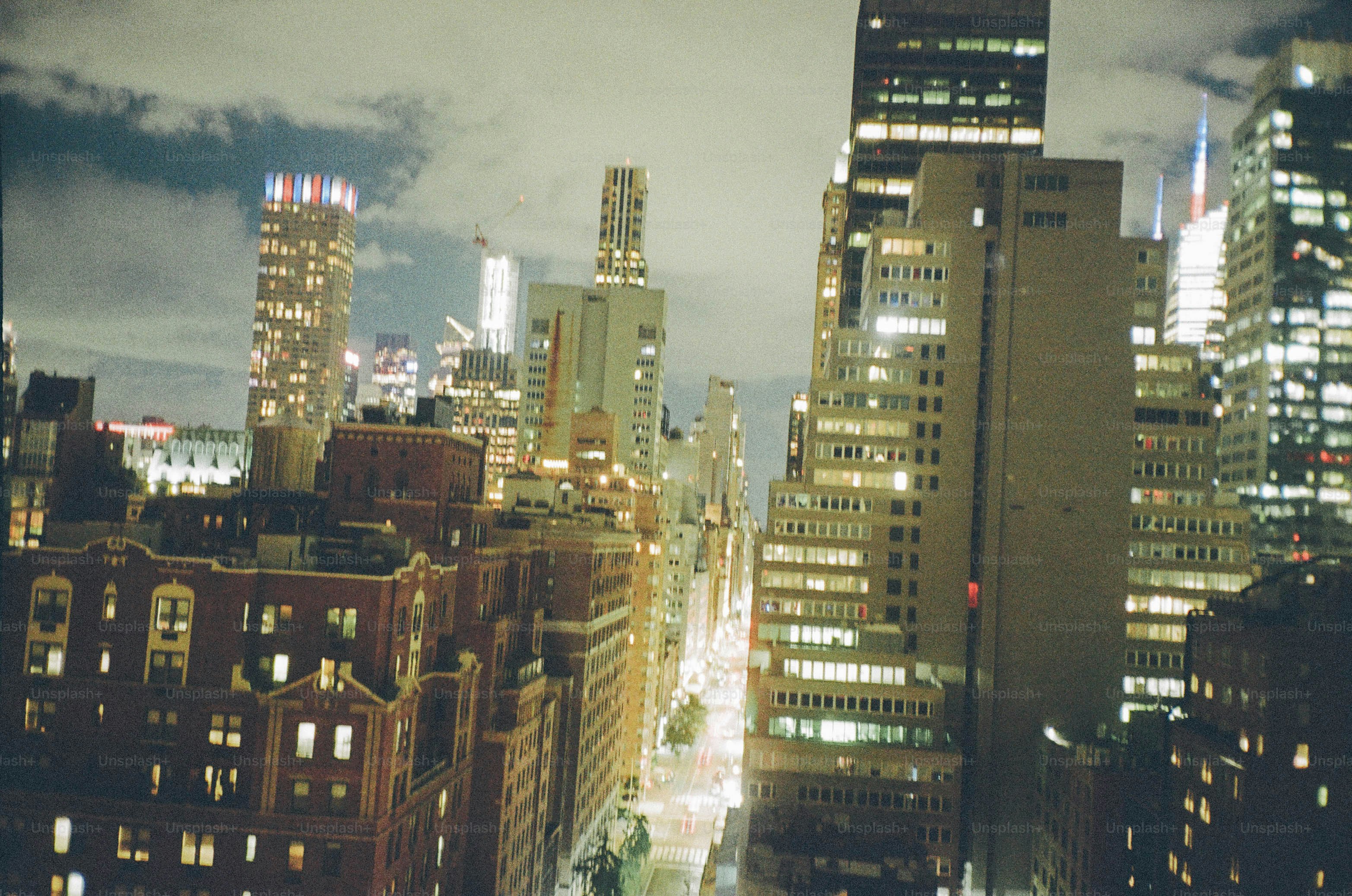 New york city skyline at night with illuminated buildings. photo ...