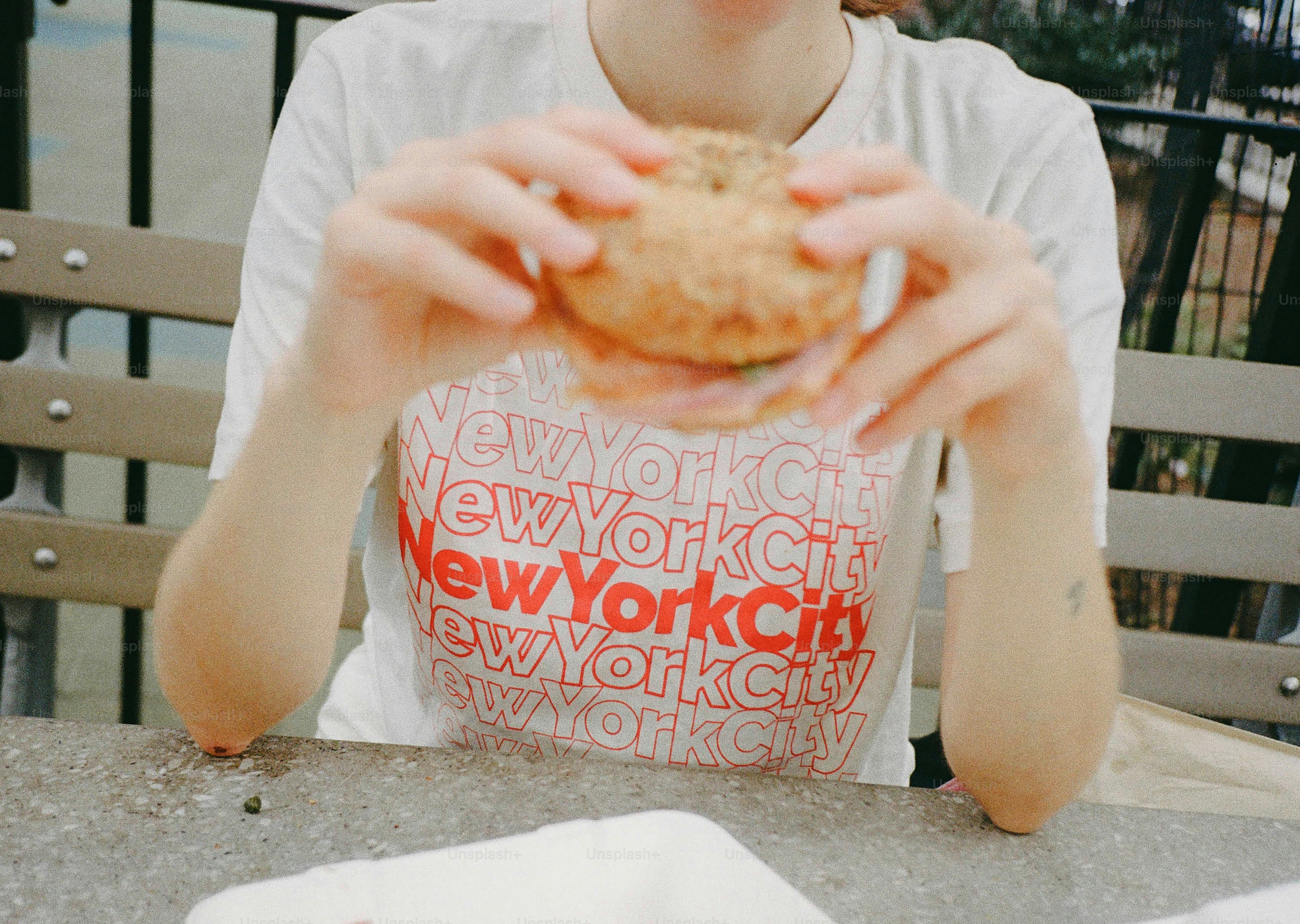 Person holding a sandwich at a table