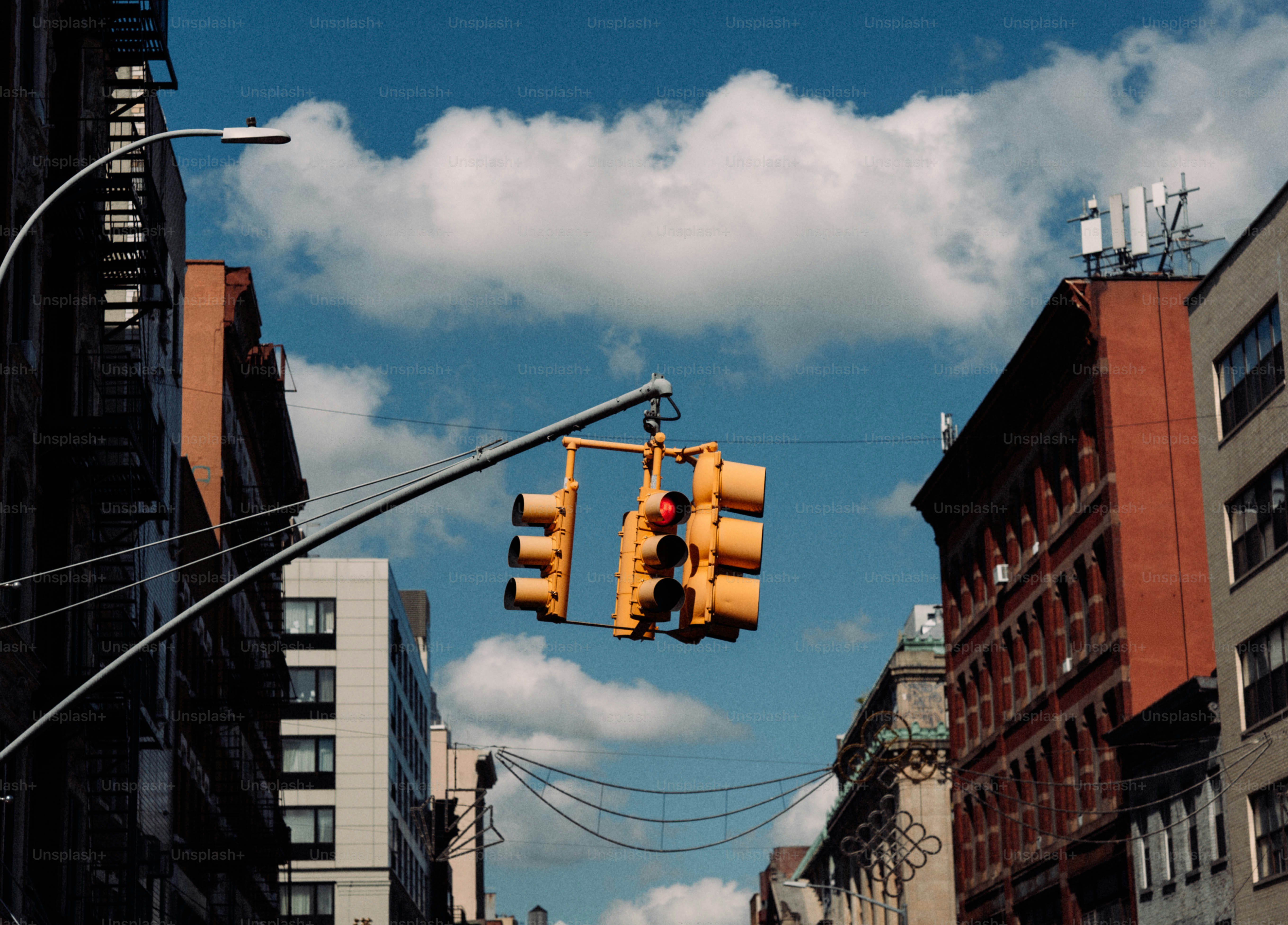 Traffic lights hang over a city street.