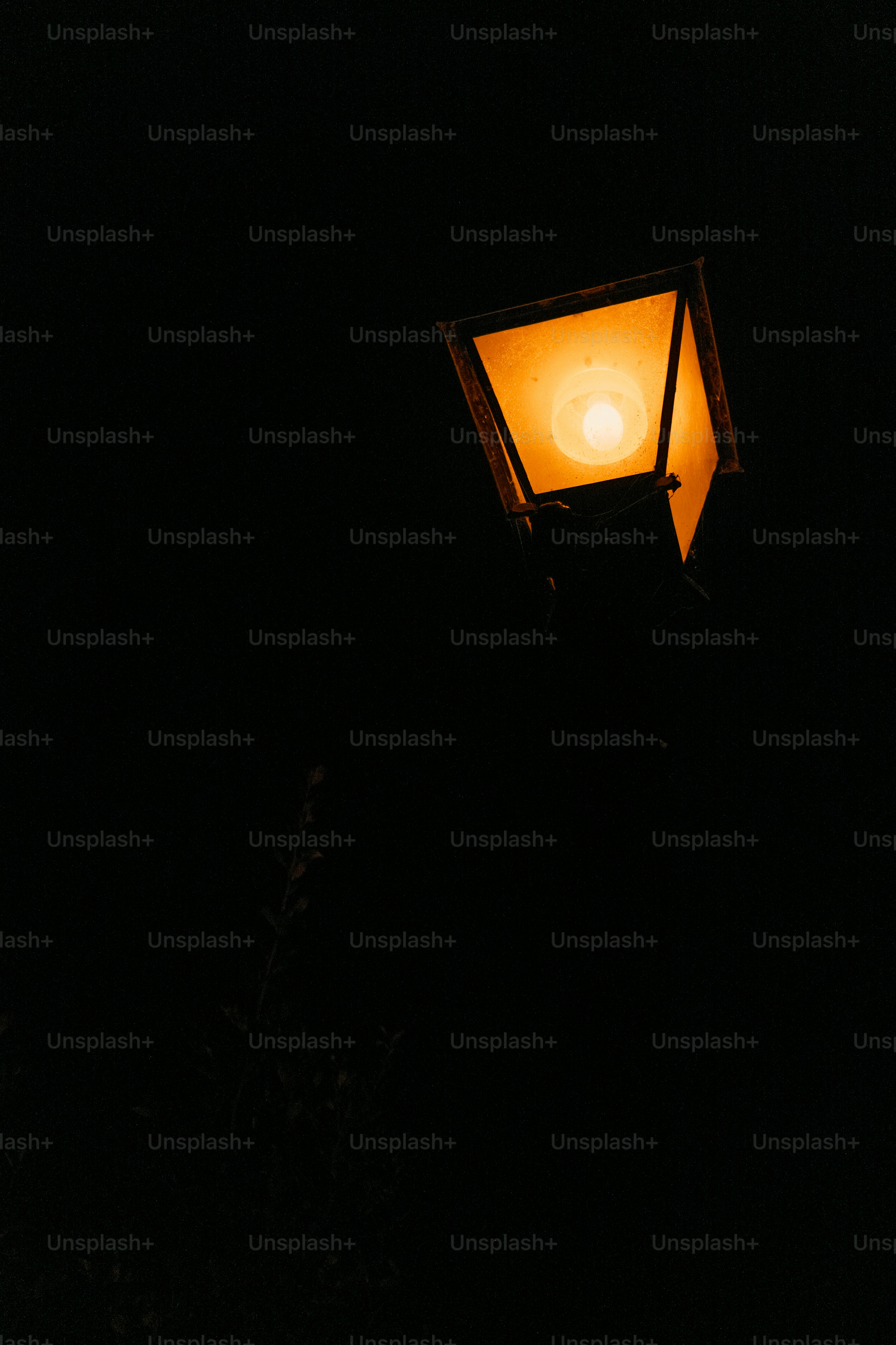 A lit street lamp at night
