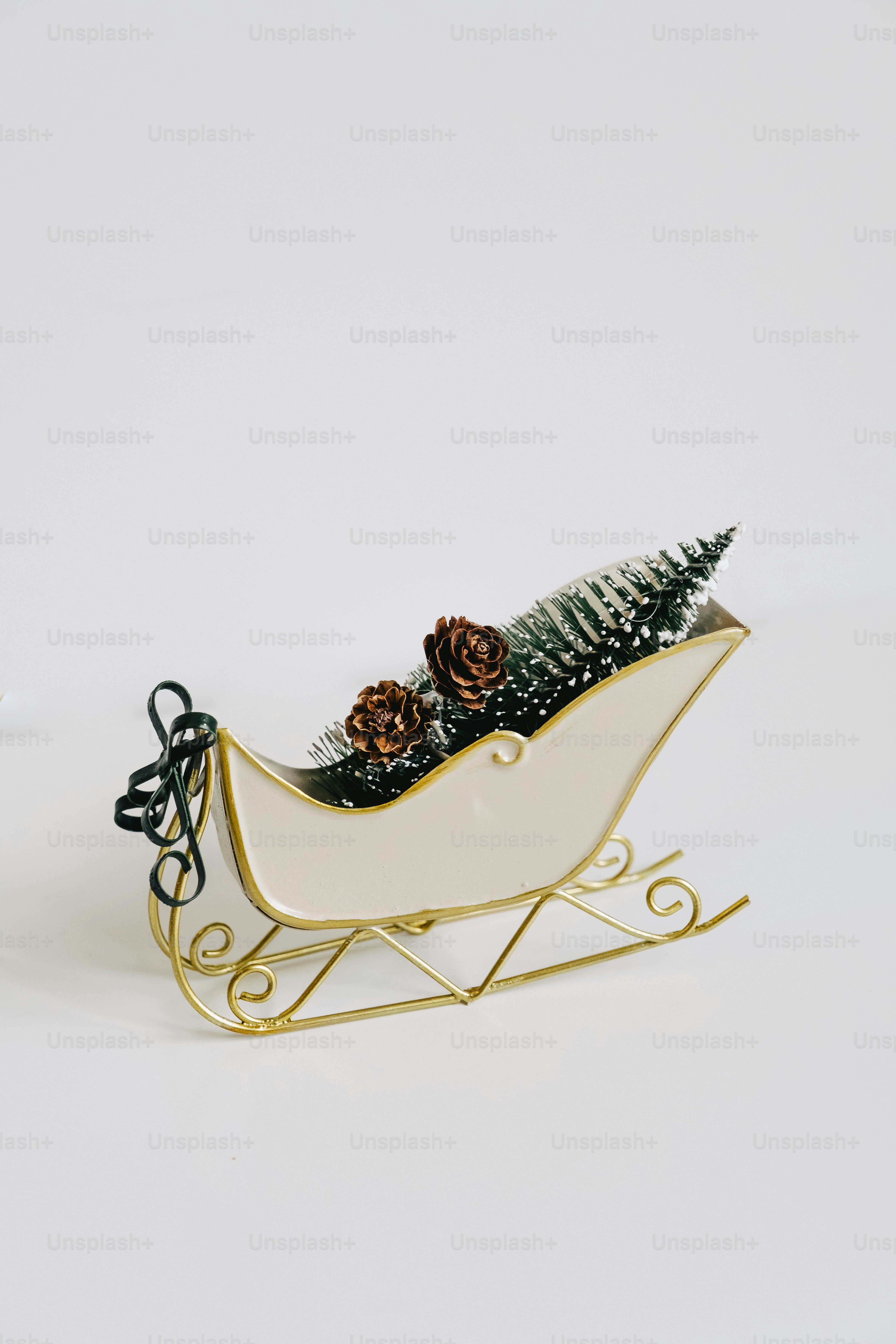 Cream sleigh with pine trees and pinecones