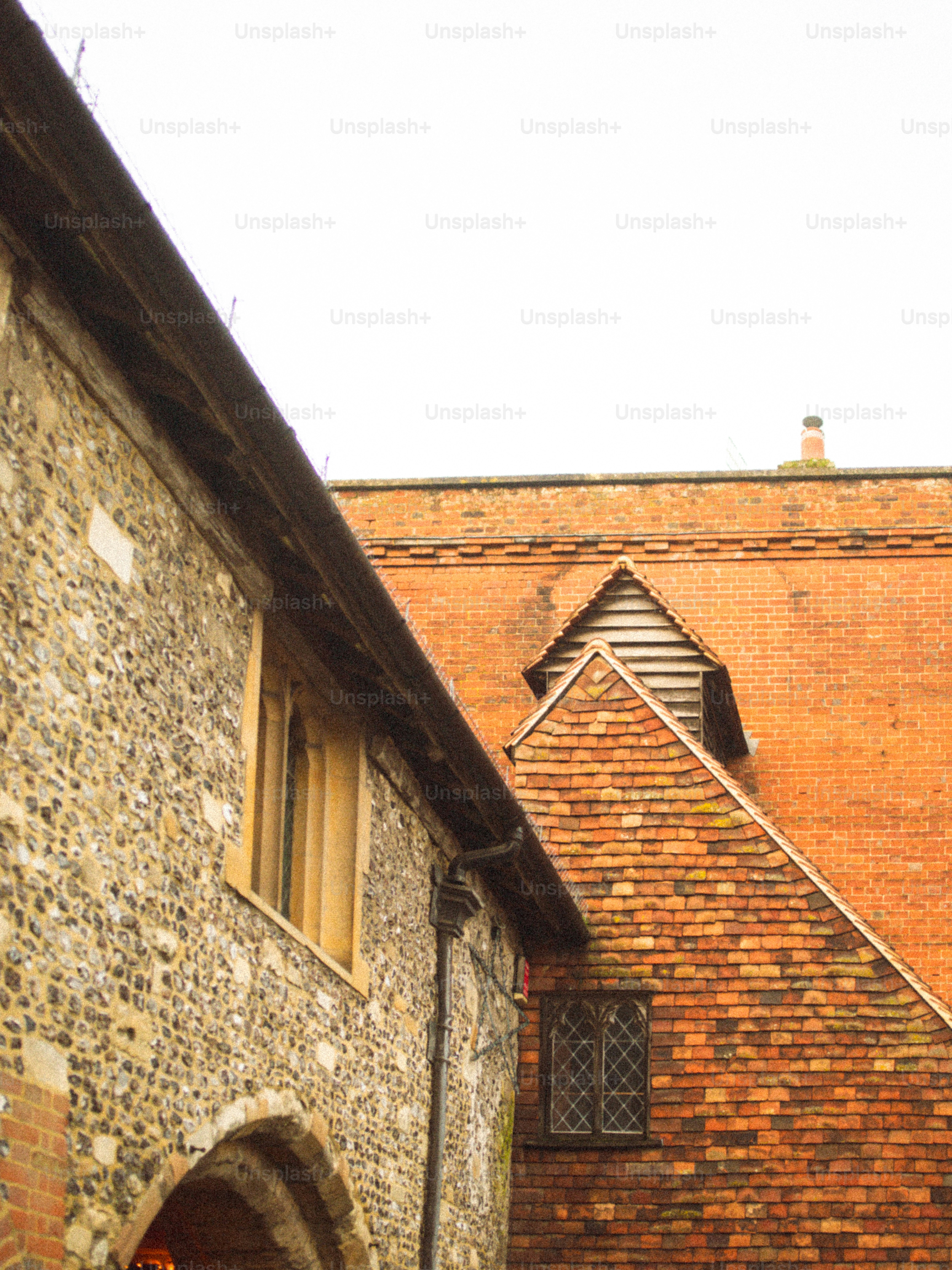 Stone and brick buildings with tiled roofs.