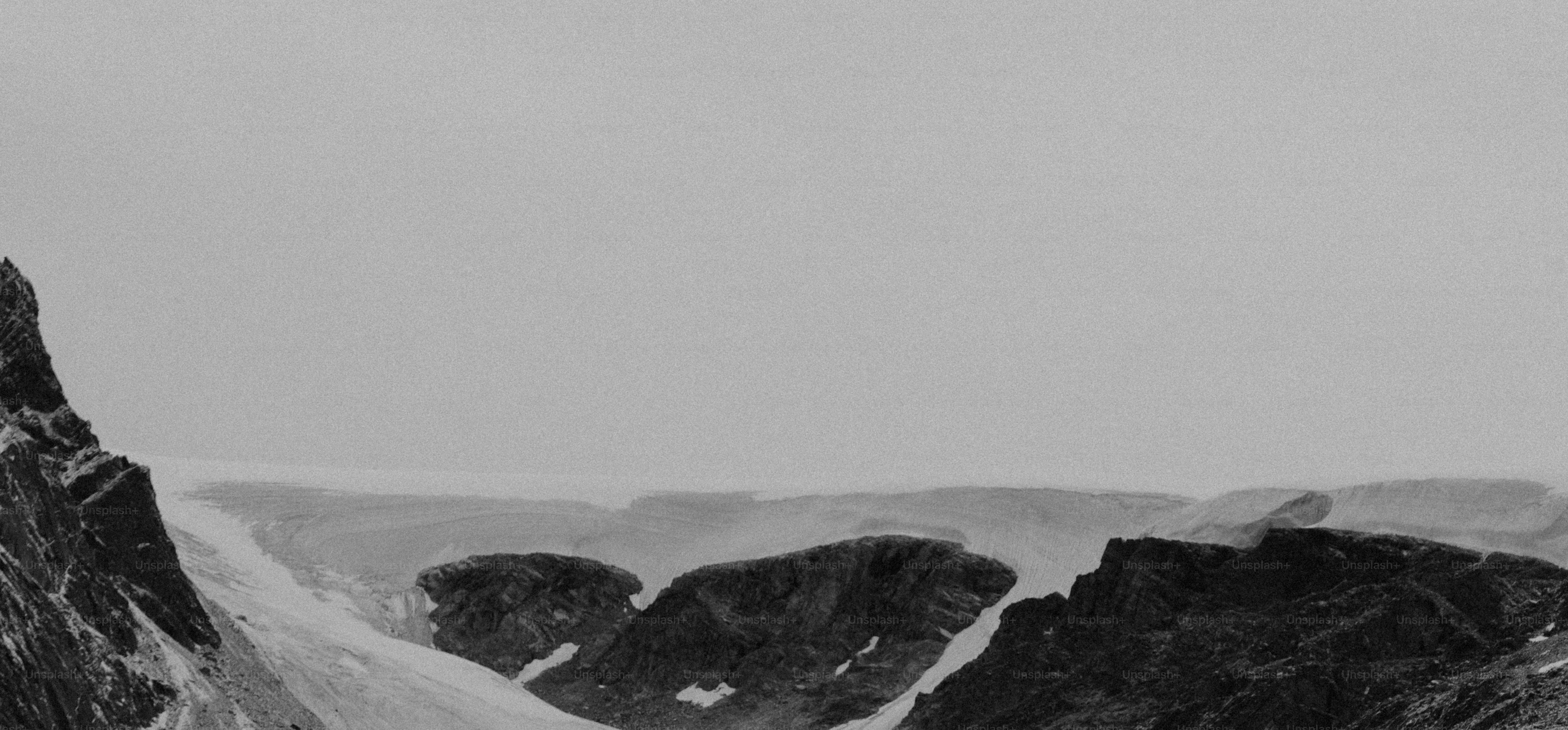 Snowy mountain peaks under a cloudy sky