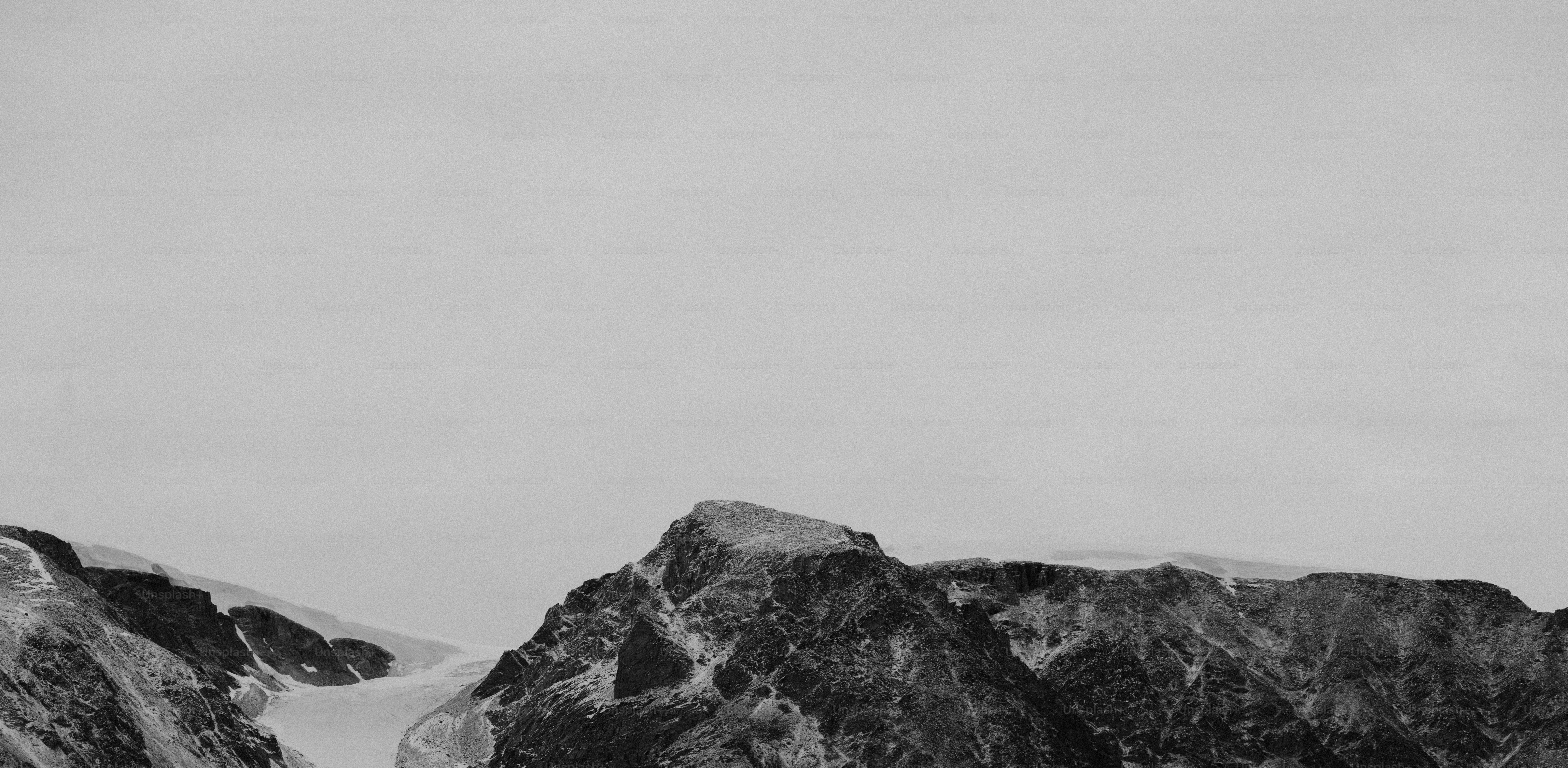 Jagged mountain peaks under a vast, clear sky