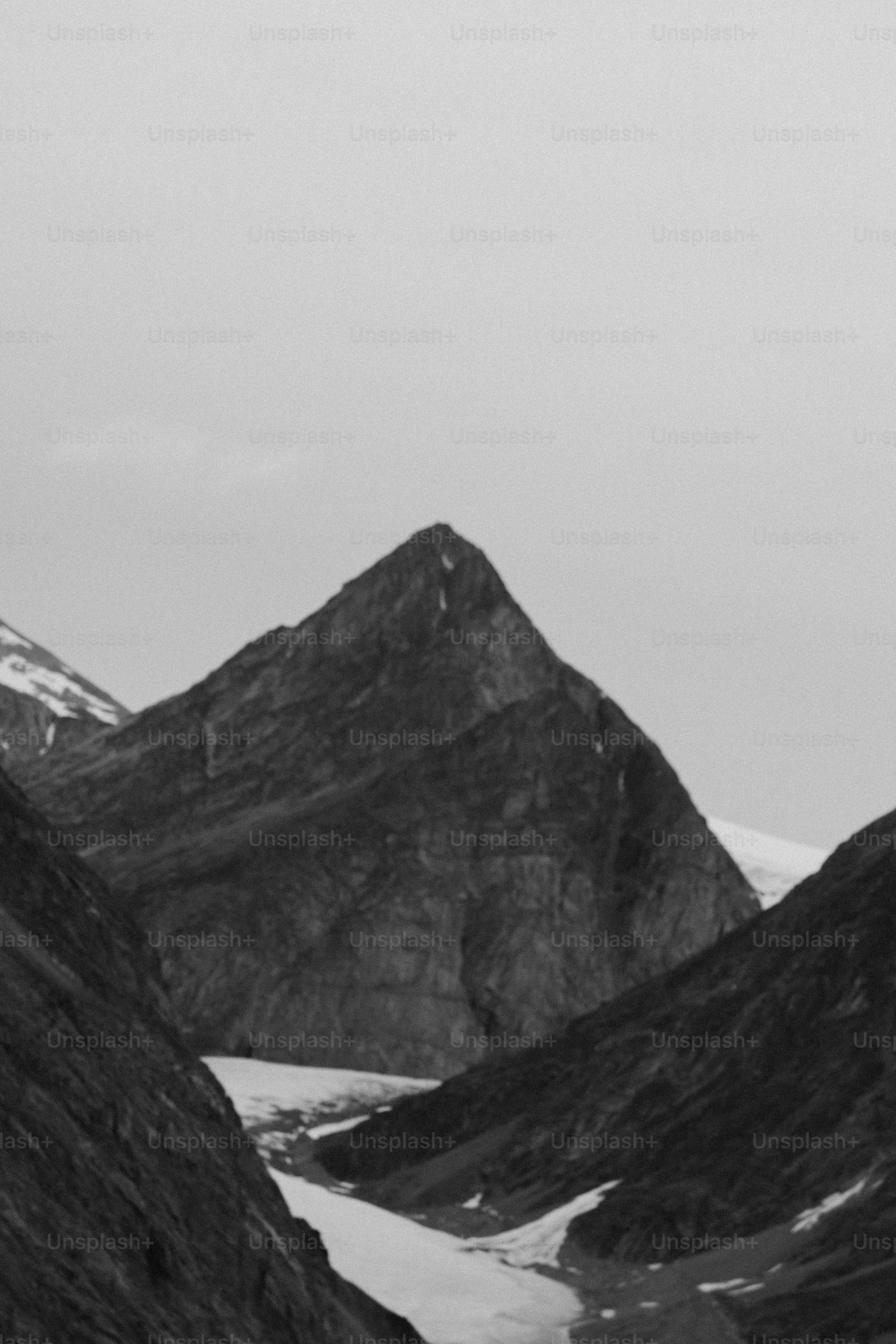 Jagged mountain peaks with snow and clouds