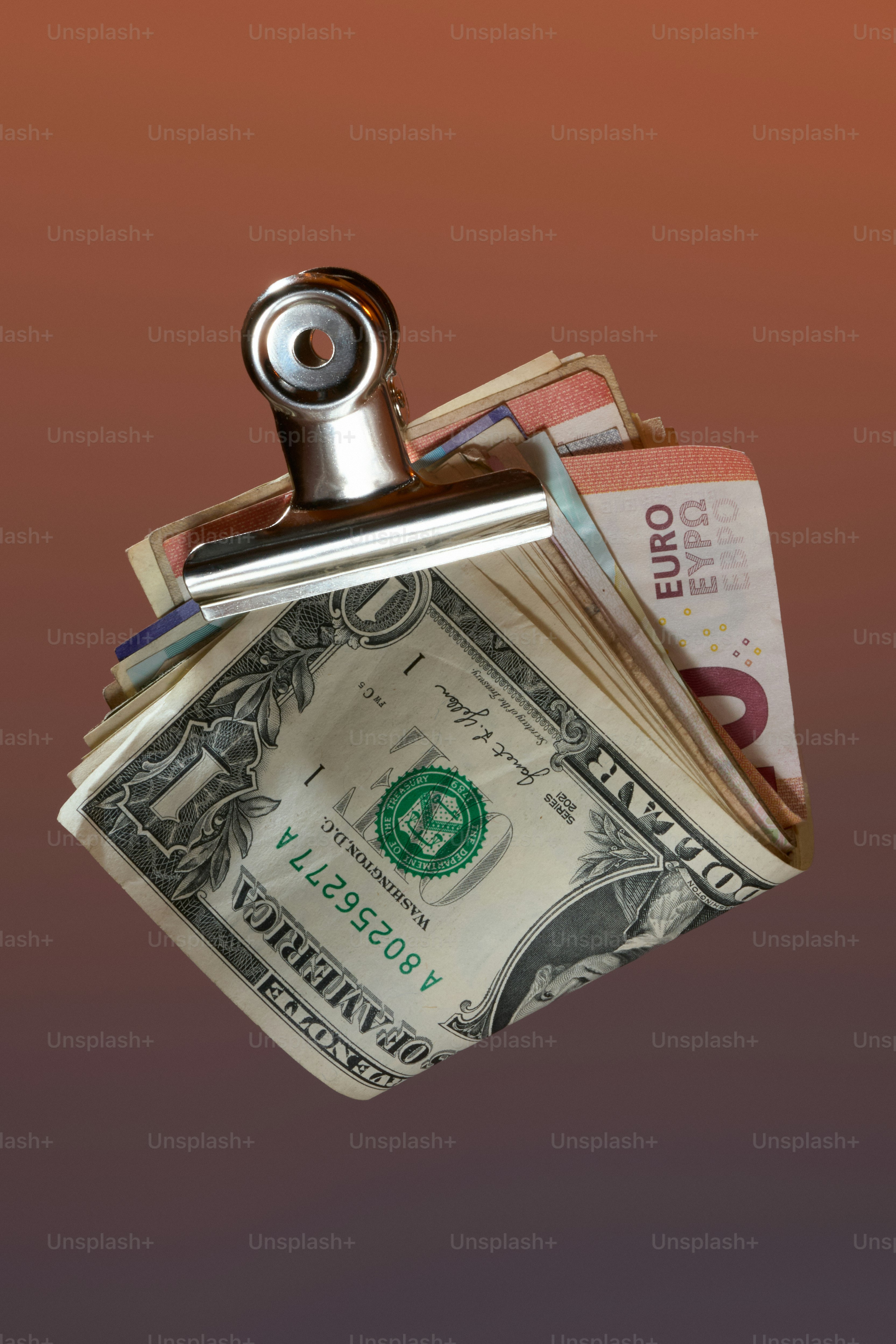 Money clip holding dollar and euro bills.
