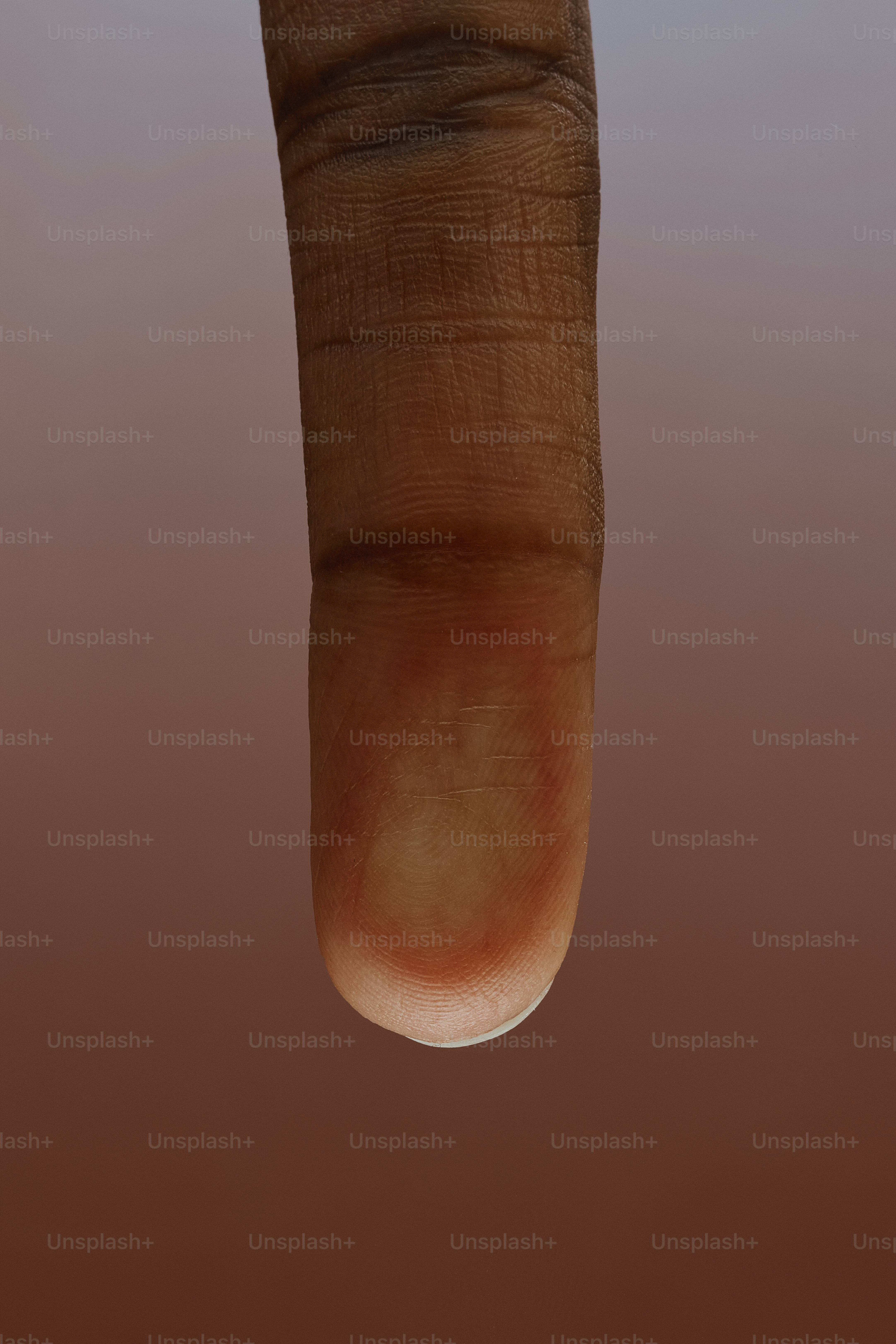 Close-up of a fingertip with visible fingerprints.