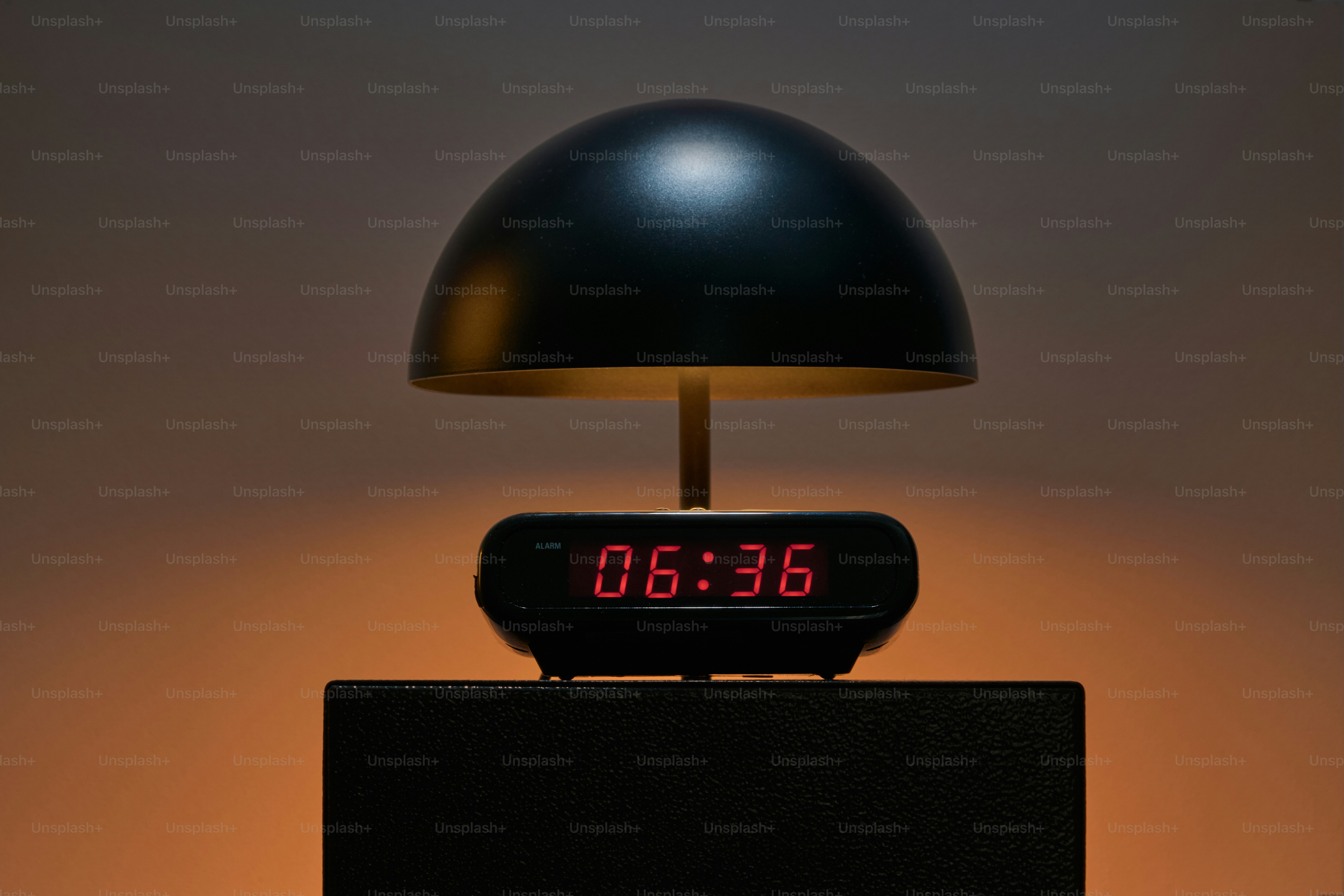 A black dome lamp with a digital clock
