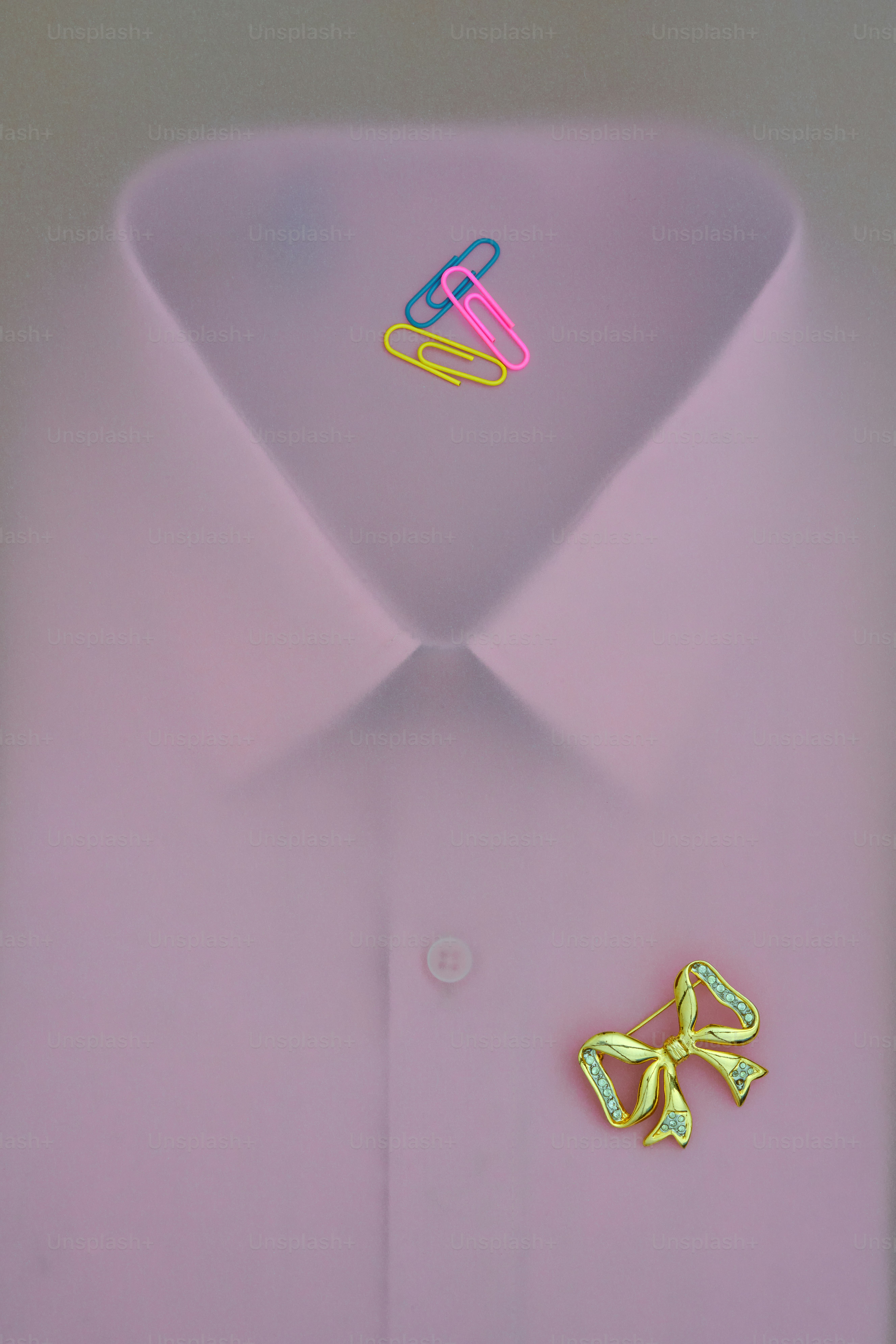 Pink collared shirt with paperclips and brooch