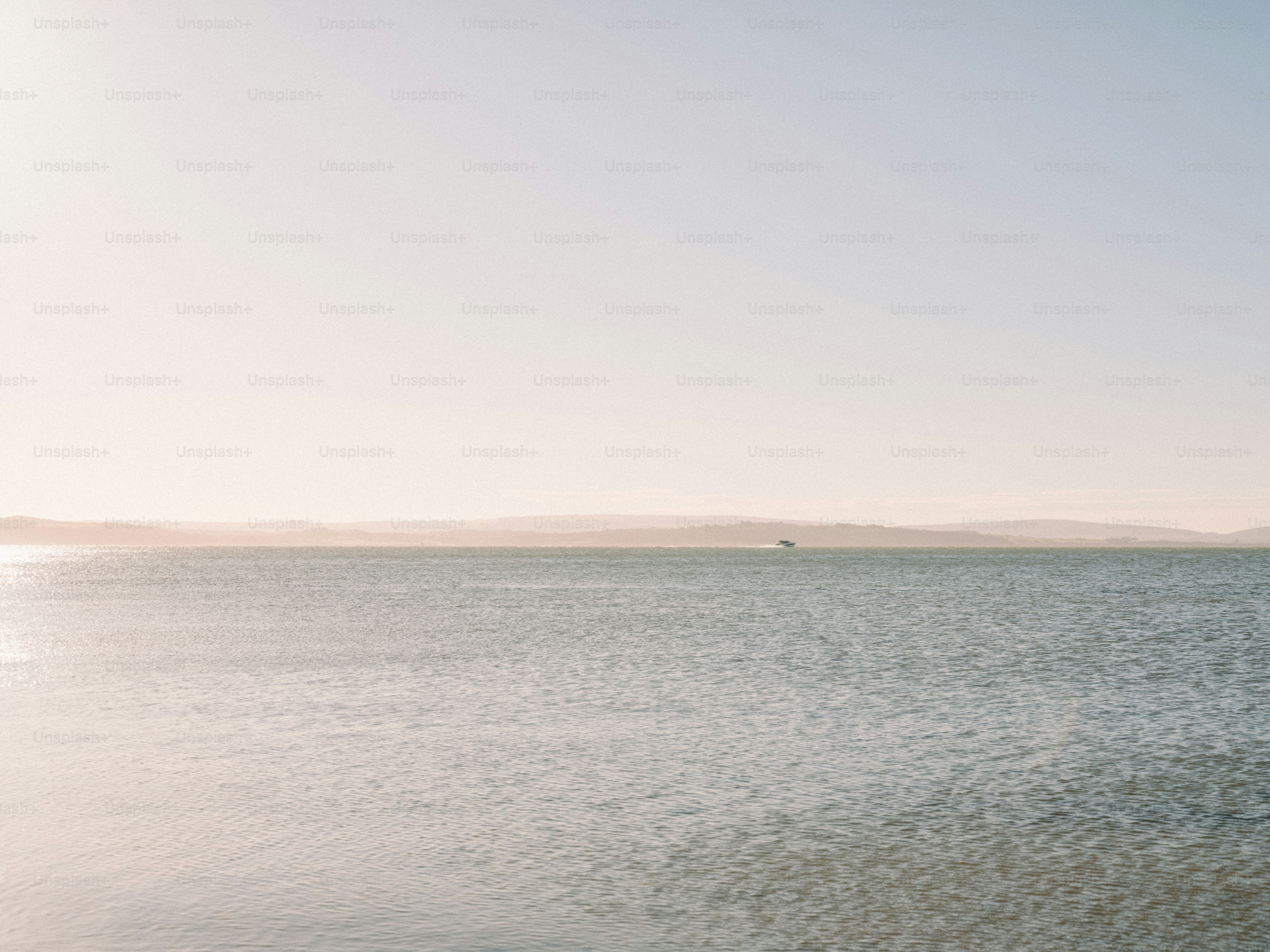 Calm ocean water with distant hazy land on horizon. photo – Sea Image ...