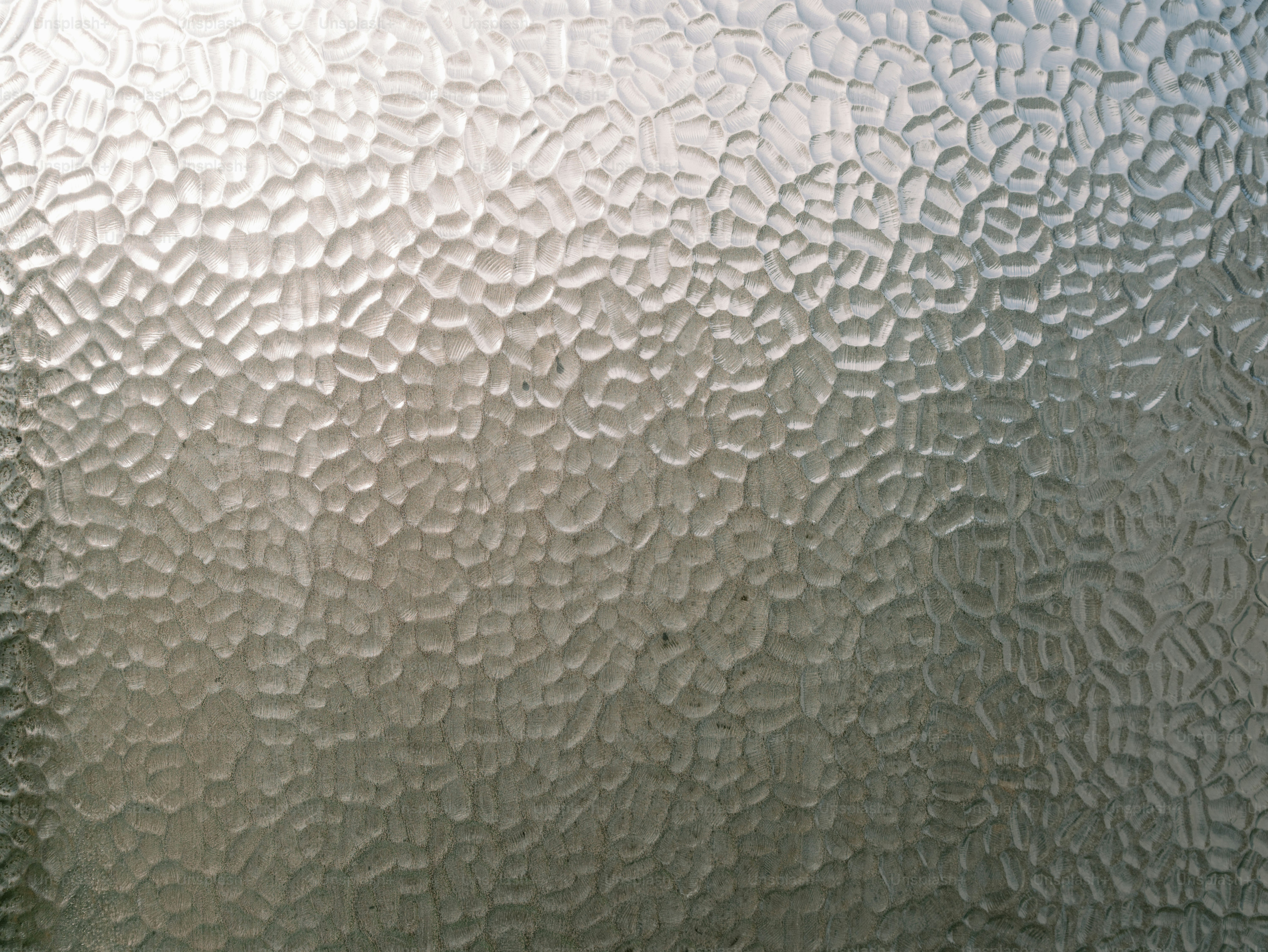 Textured frosted glass surface with light reflections