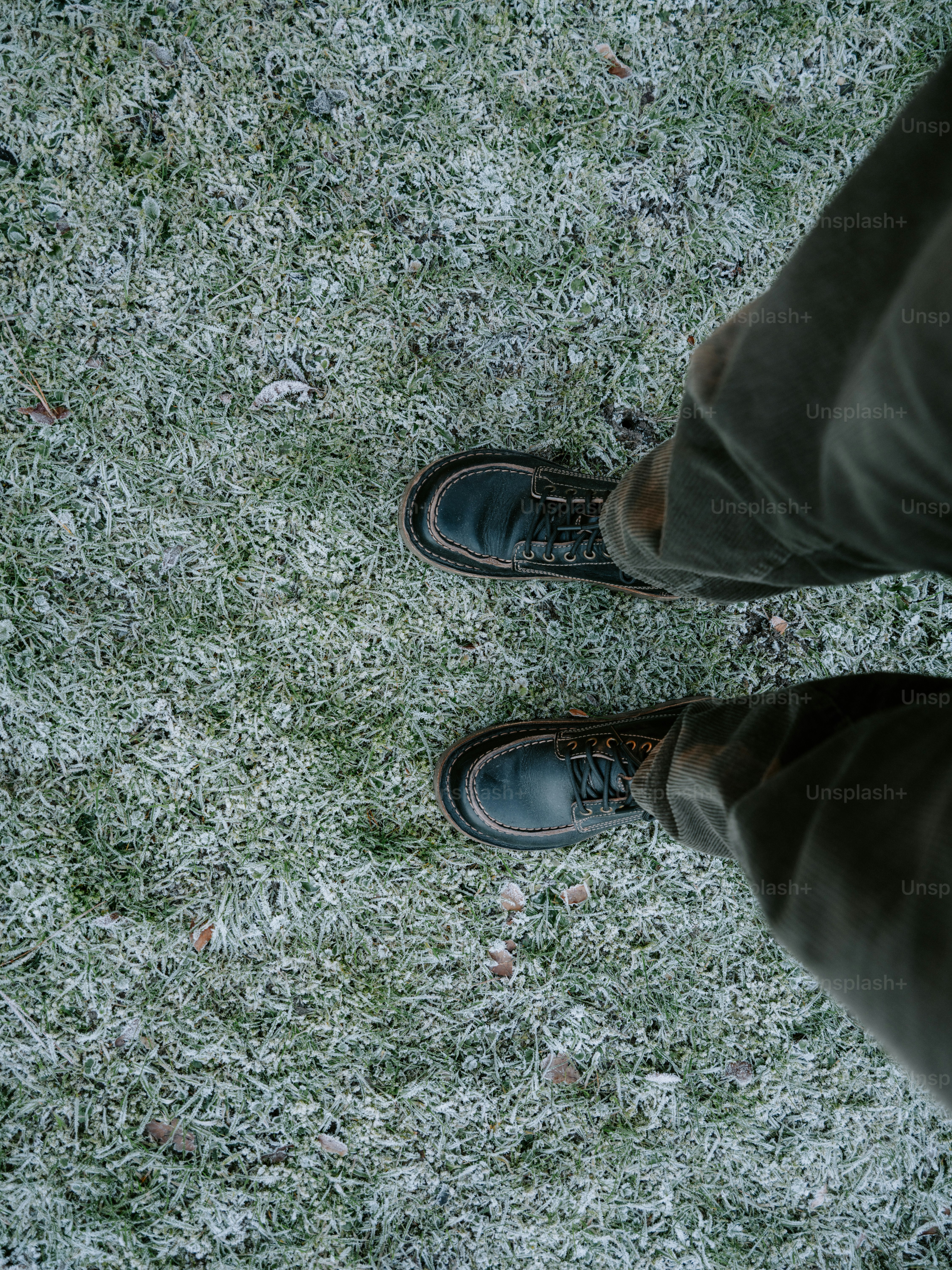 Boots on frosted grass during winter