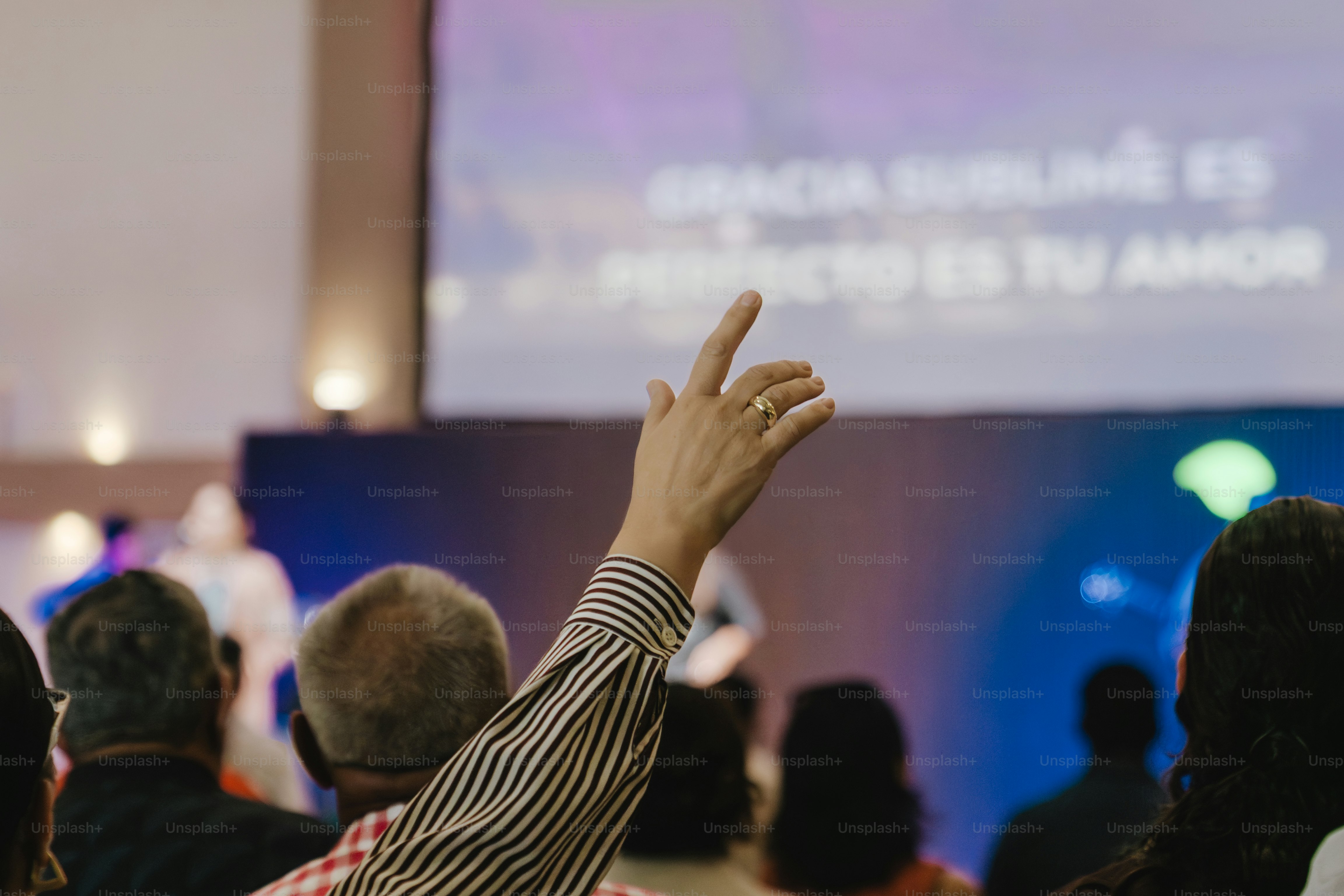 Congregation raising hands during worship service with worship music