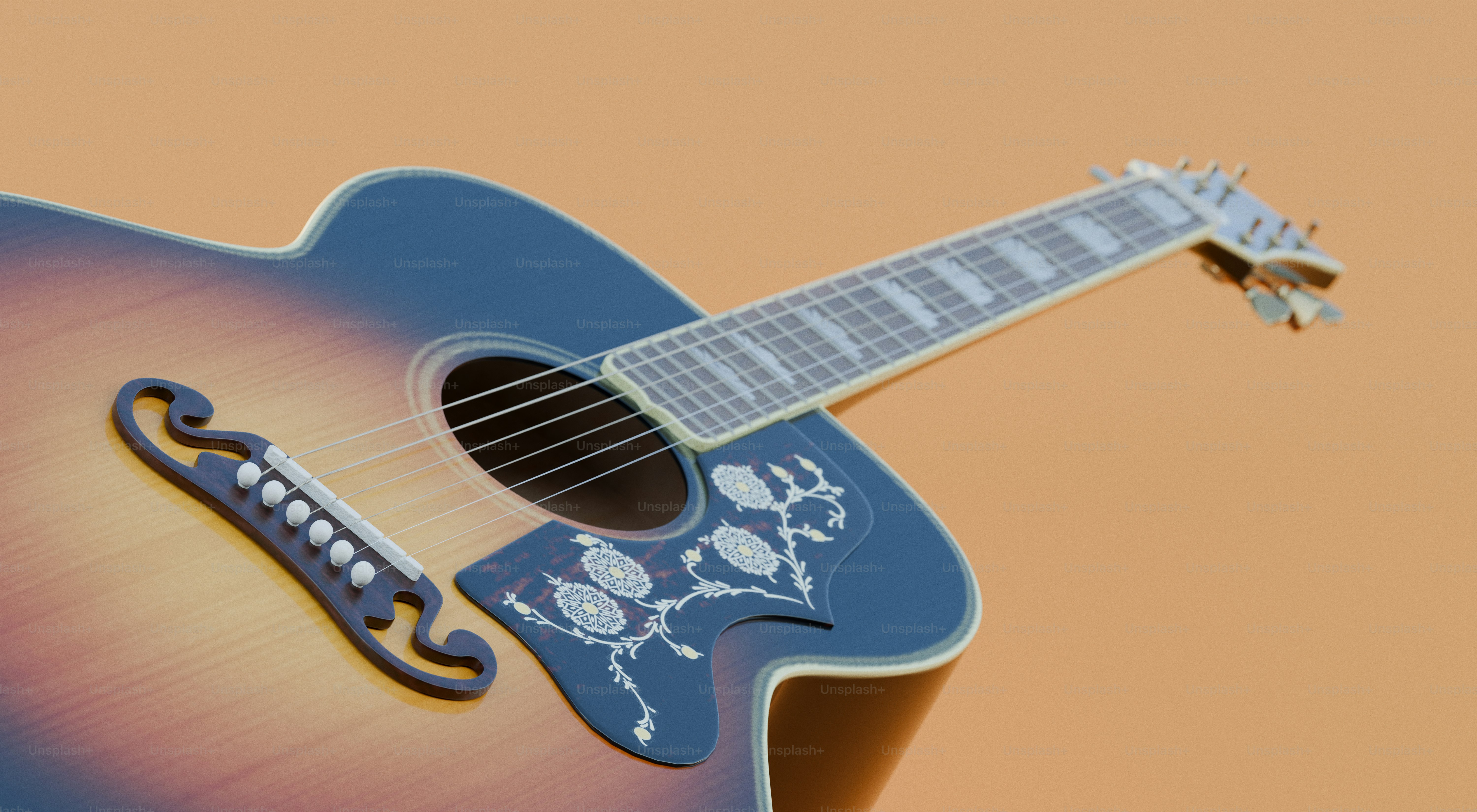 Close-up of an acoustic guitar on an orange background