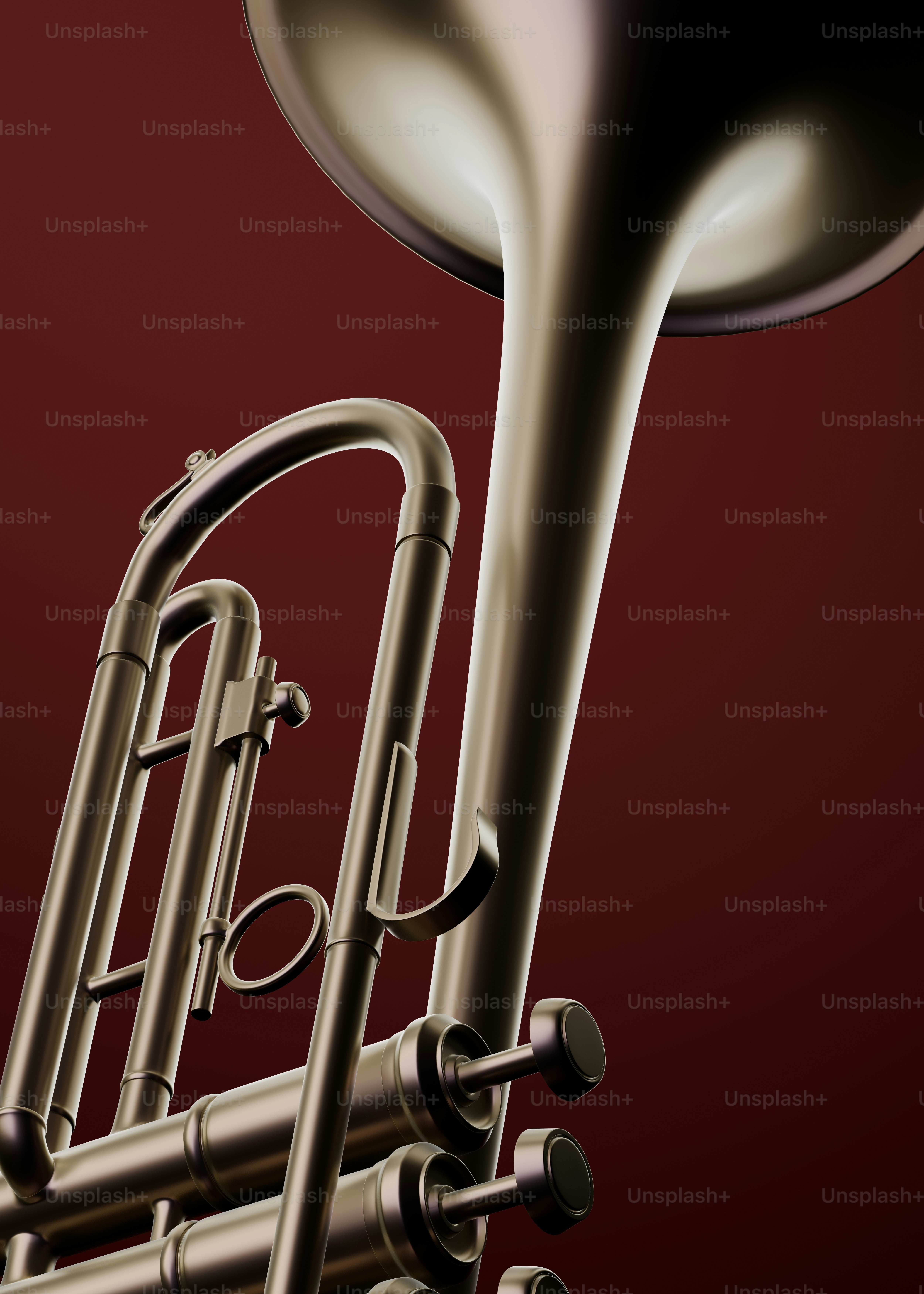 Close-up of a brass trumpet on a red background