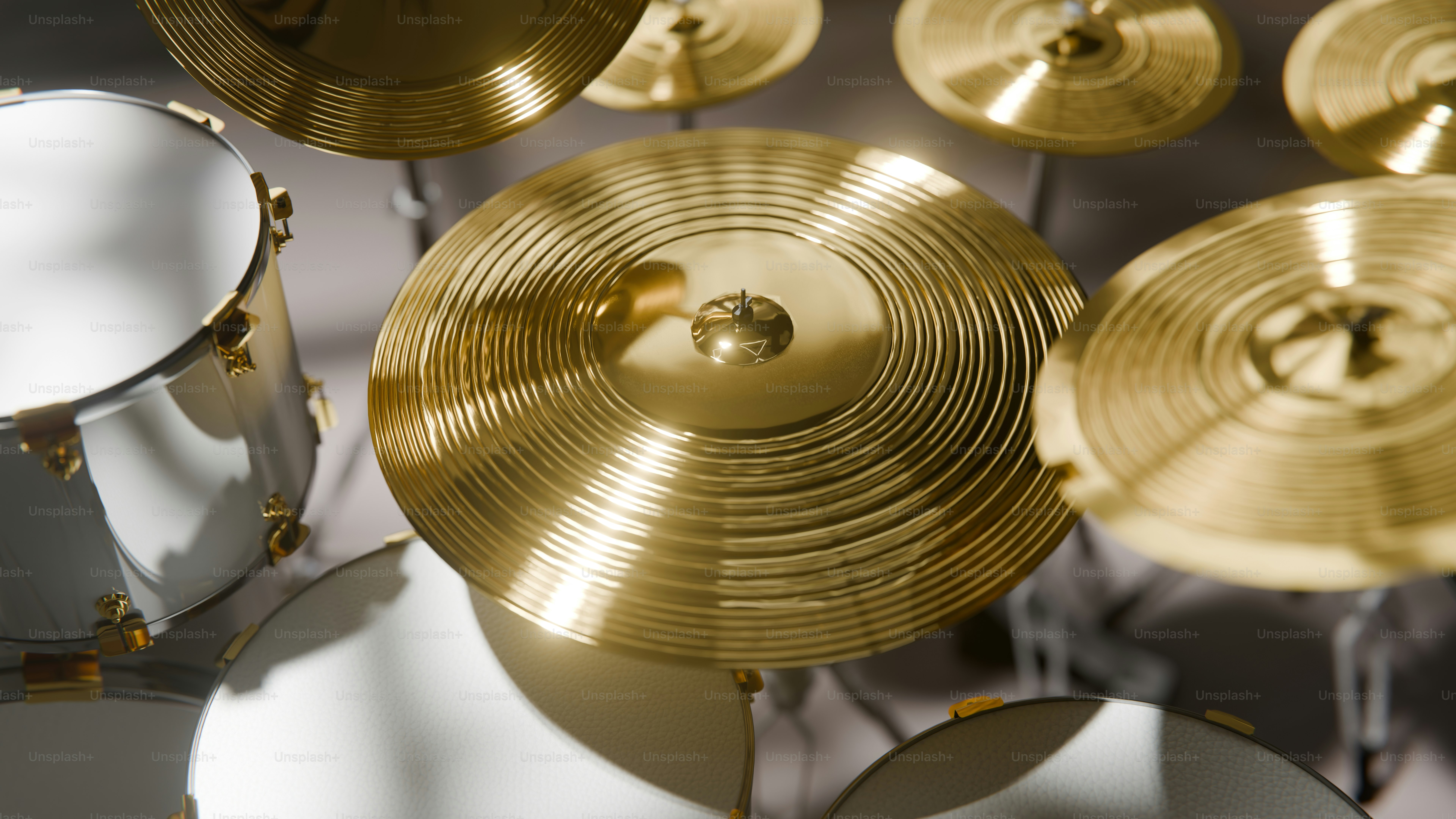 Close-up of golden cymbals and white drum heads
