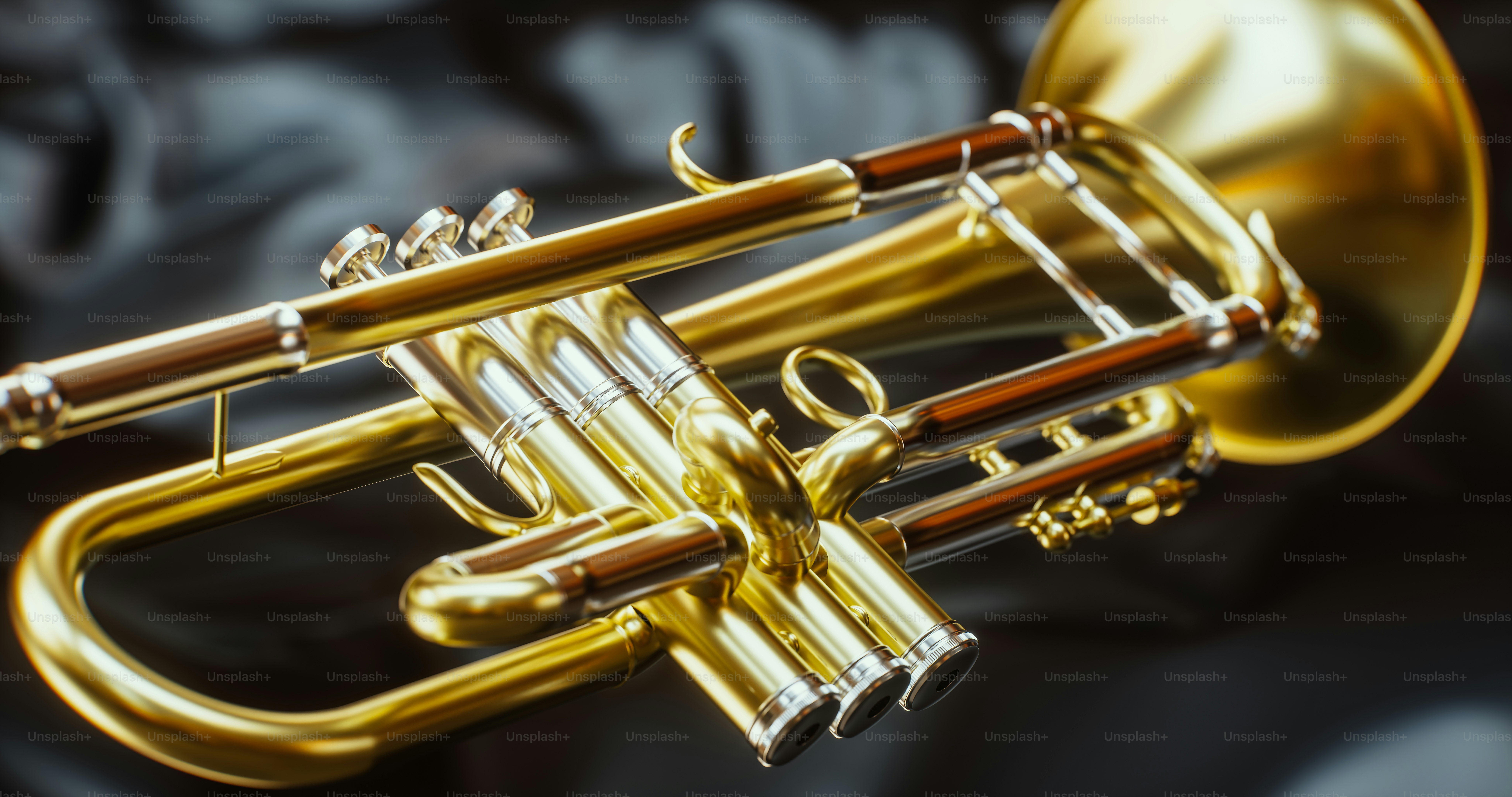 A shiny golden trumpet rests on dark fabric