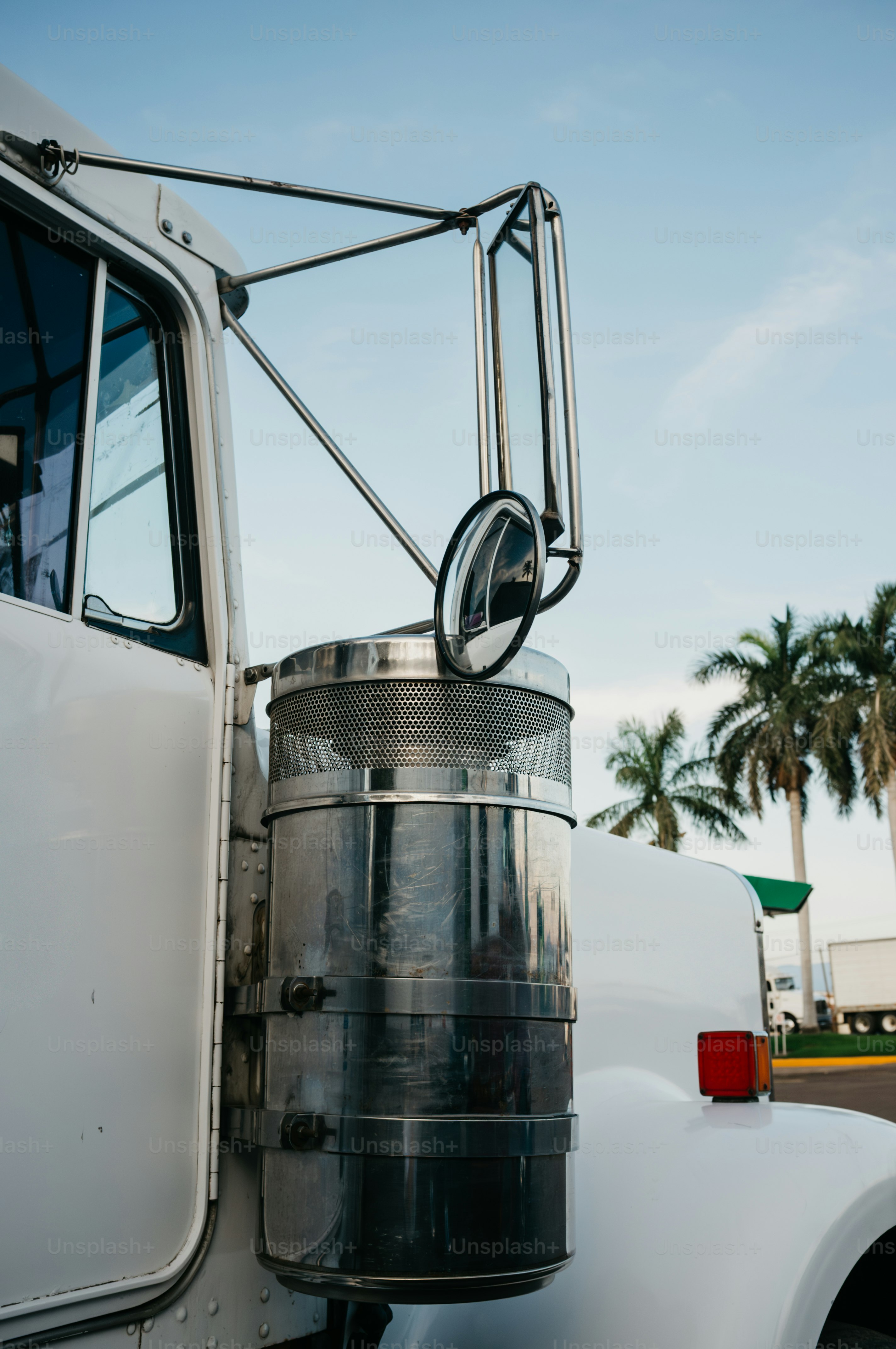 Close-up of a white semi-truck's exhaust stack.