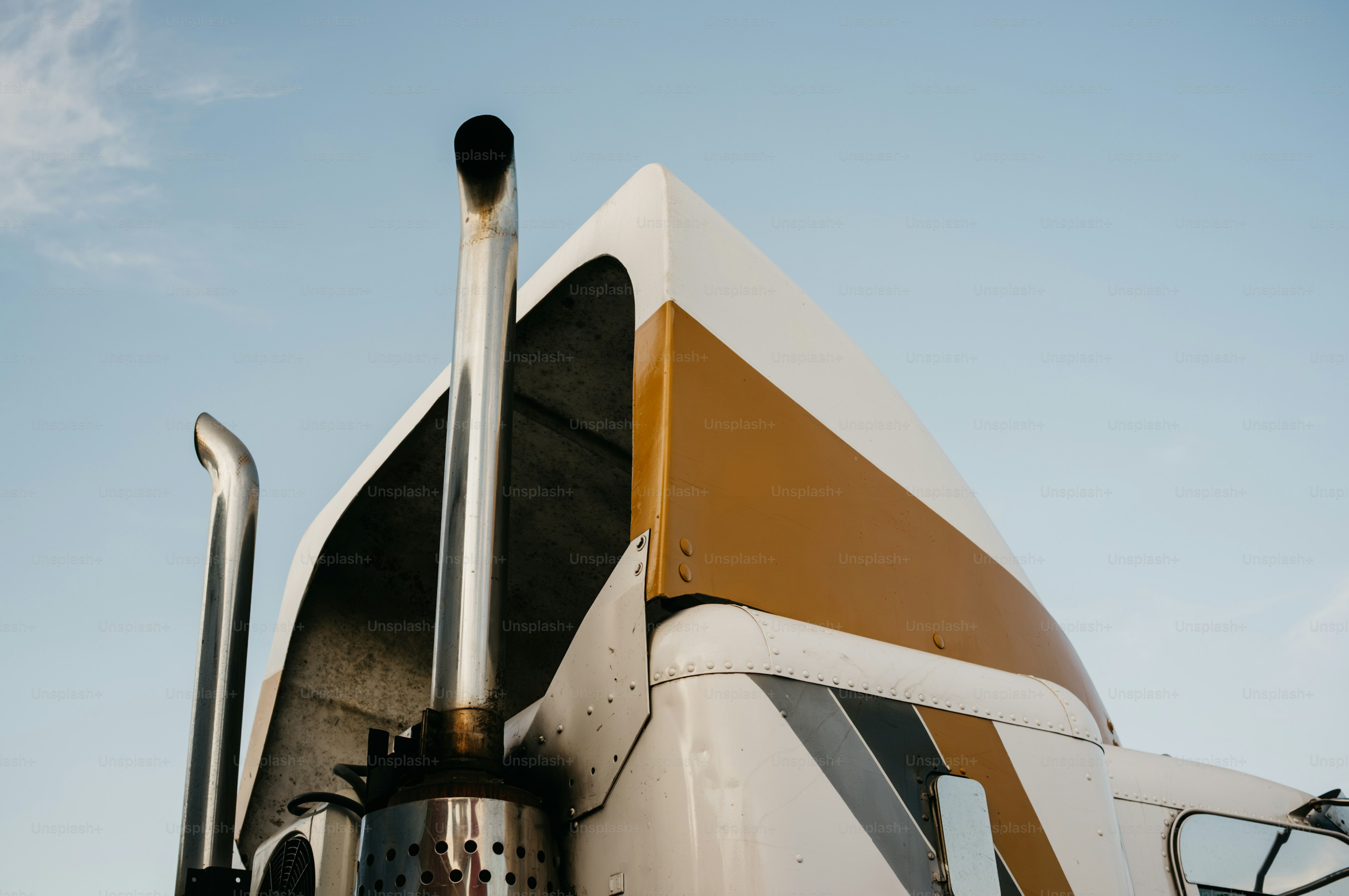 Close-up of a semi-truck exhaust stack and cab.