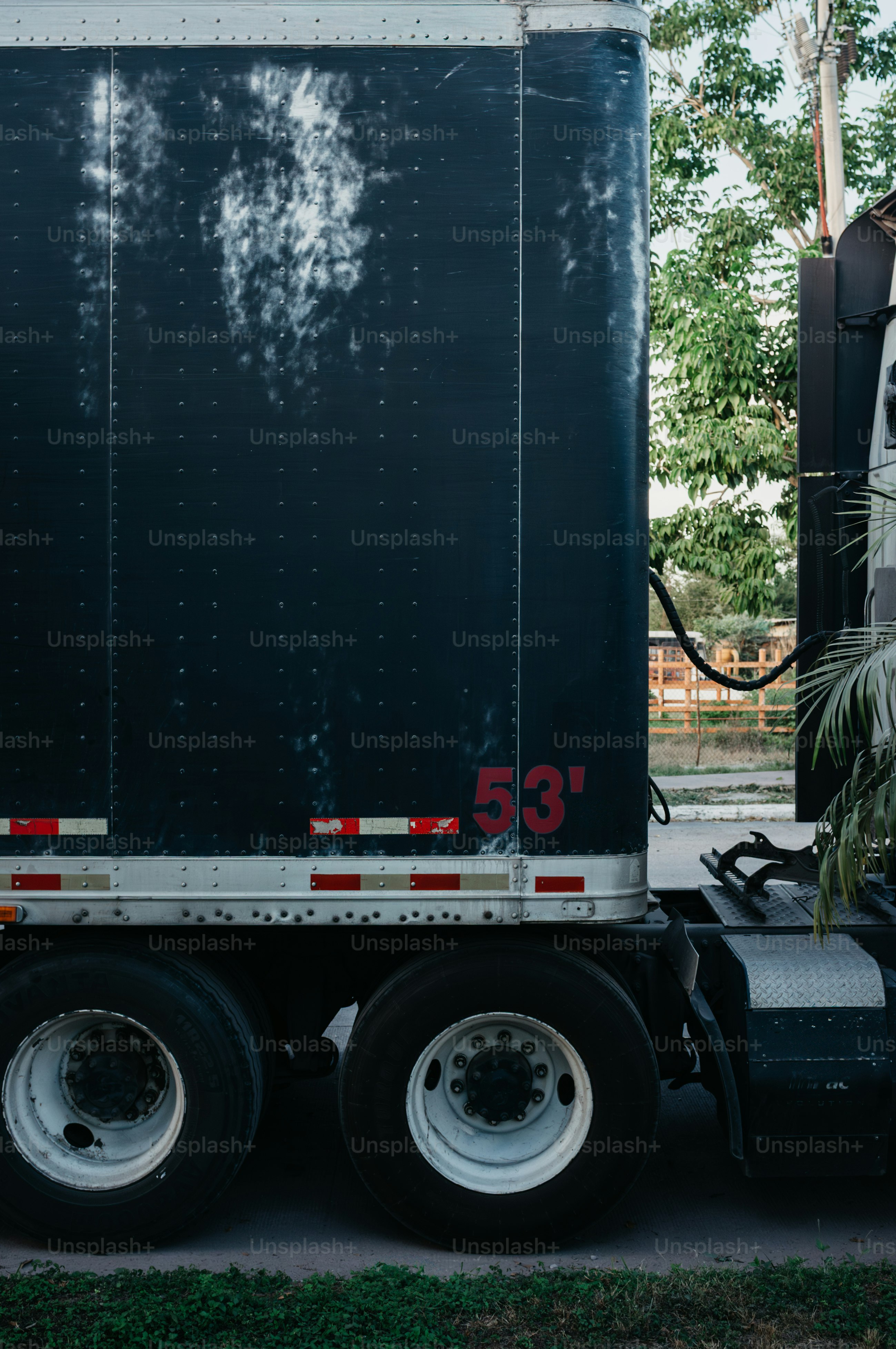 Side view of a black semi-trailer truck