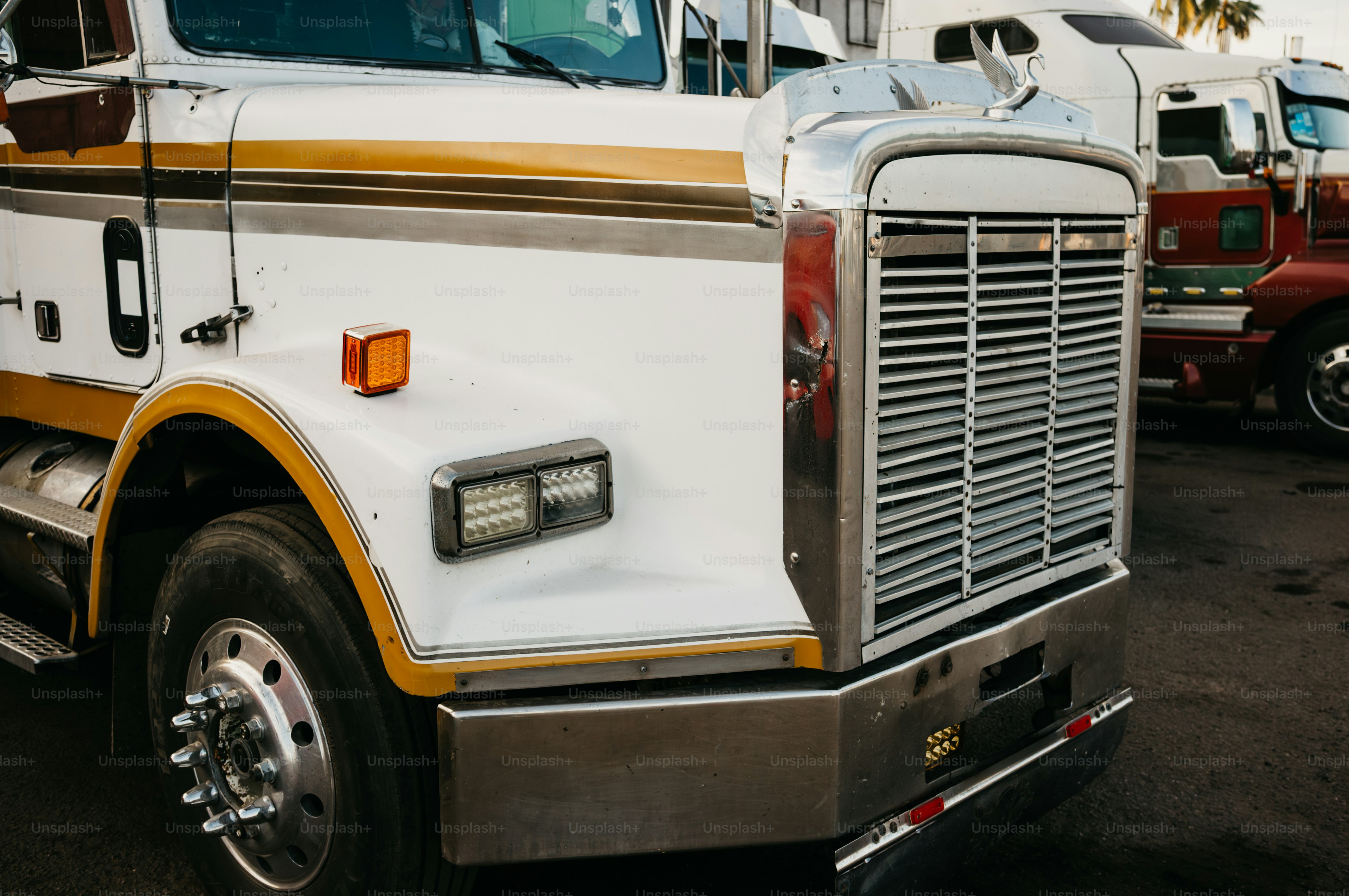 White and gold semi-truck parked outdoors.