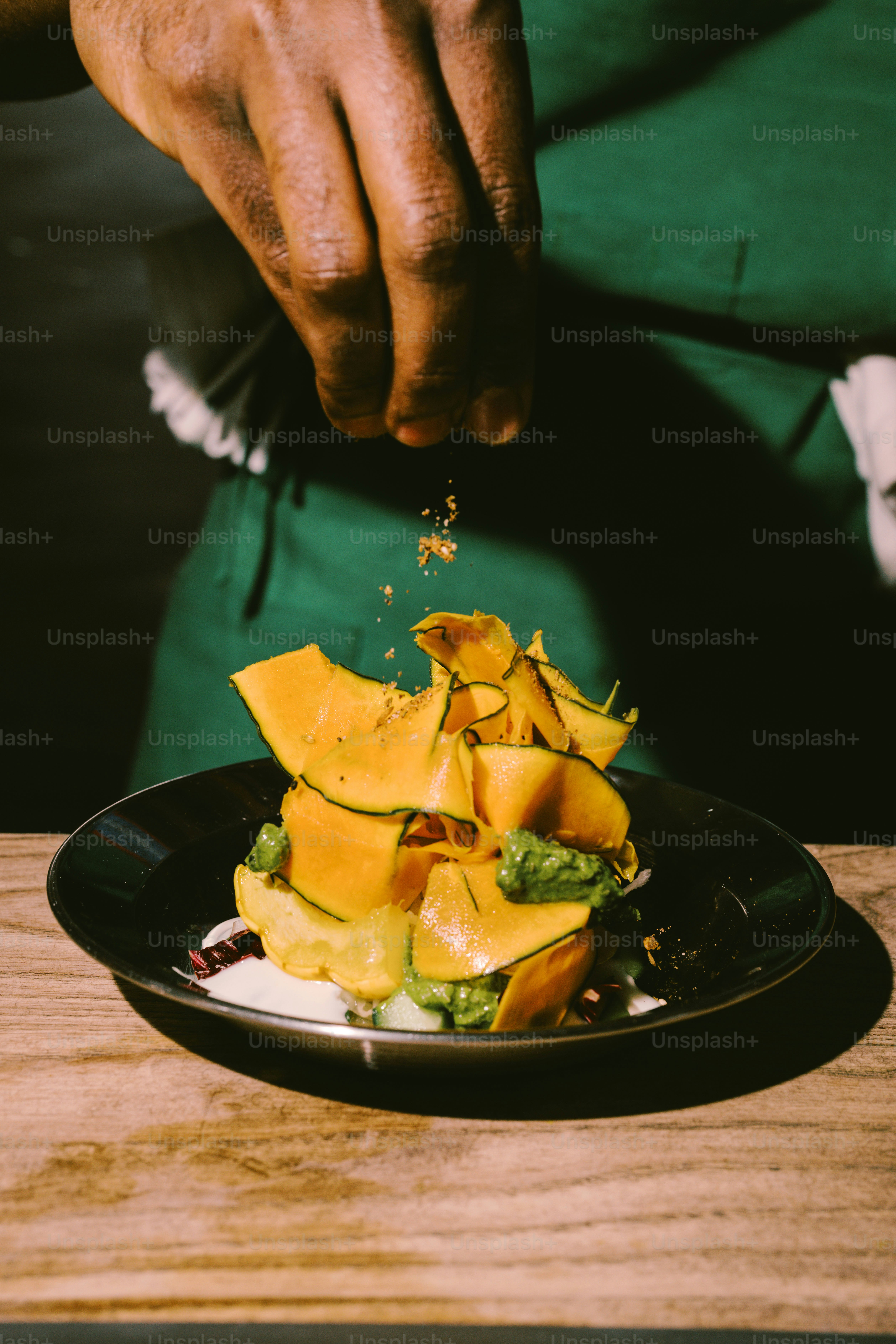 Chef garnishing a pumpkin dish with spices.