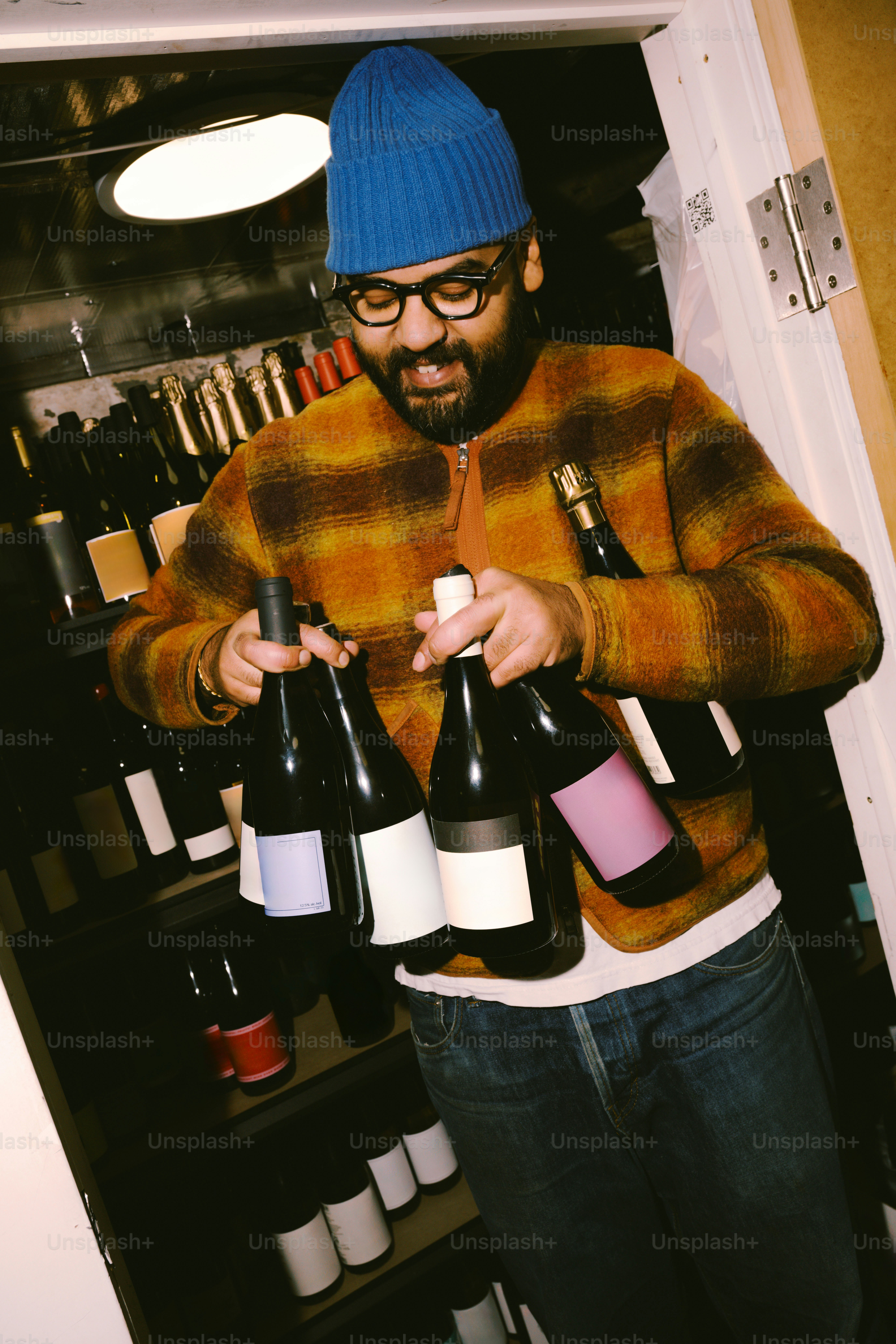 Man holding several bottles of wine