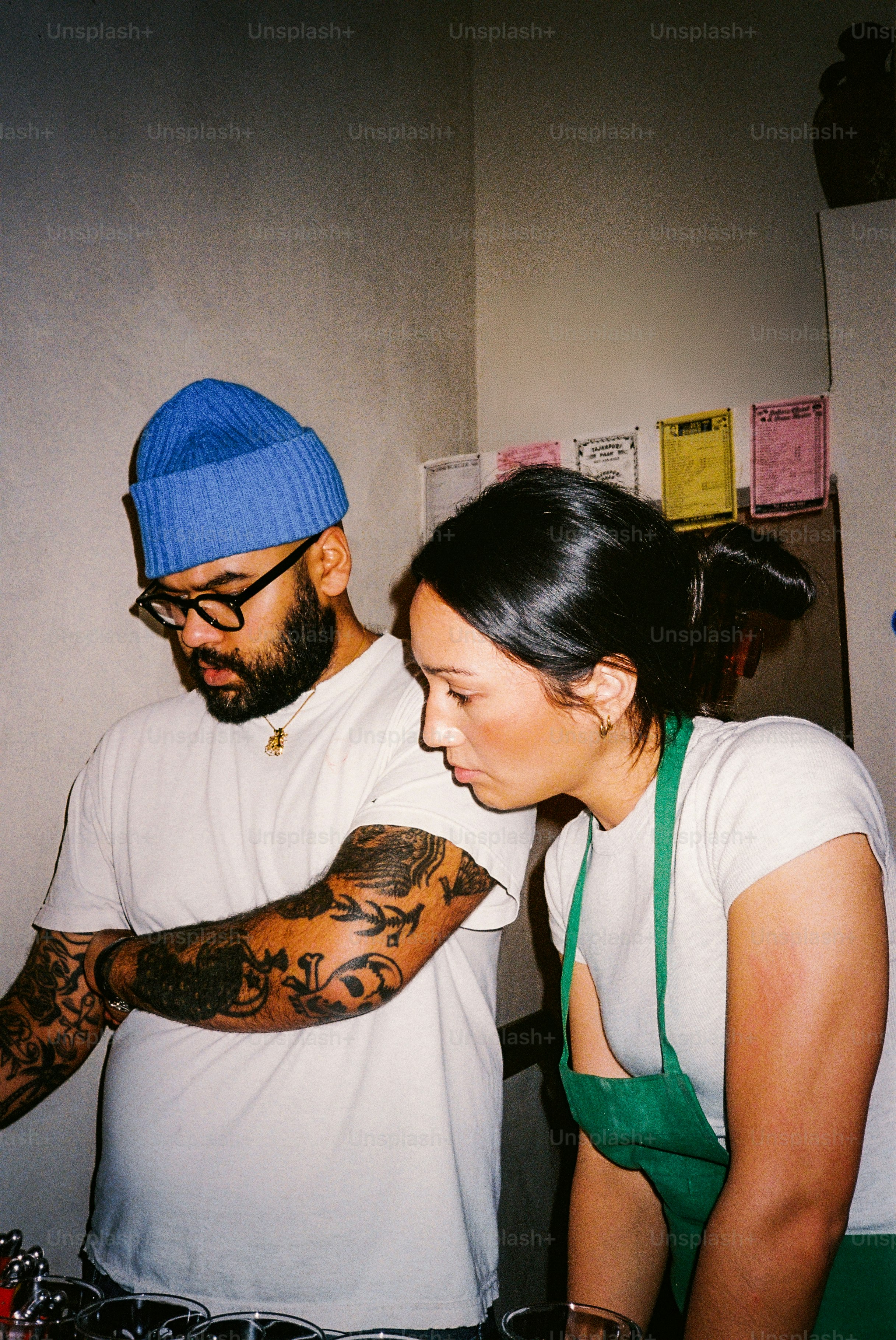 Man and woman preparing drinks together