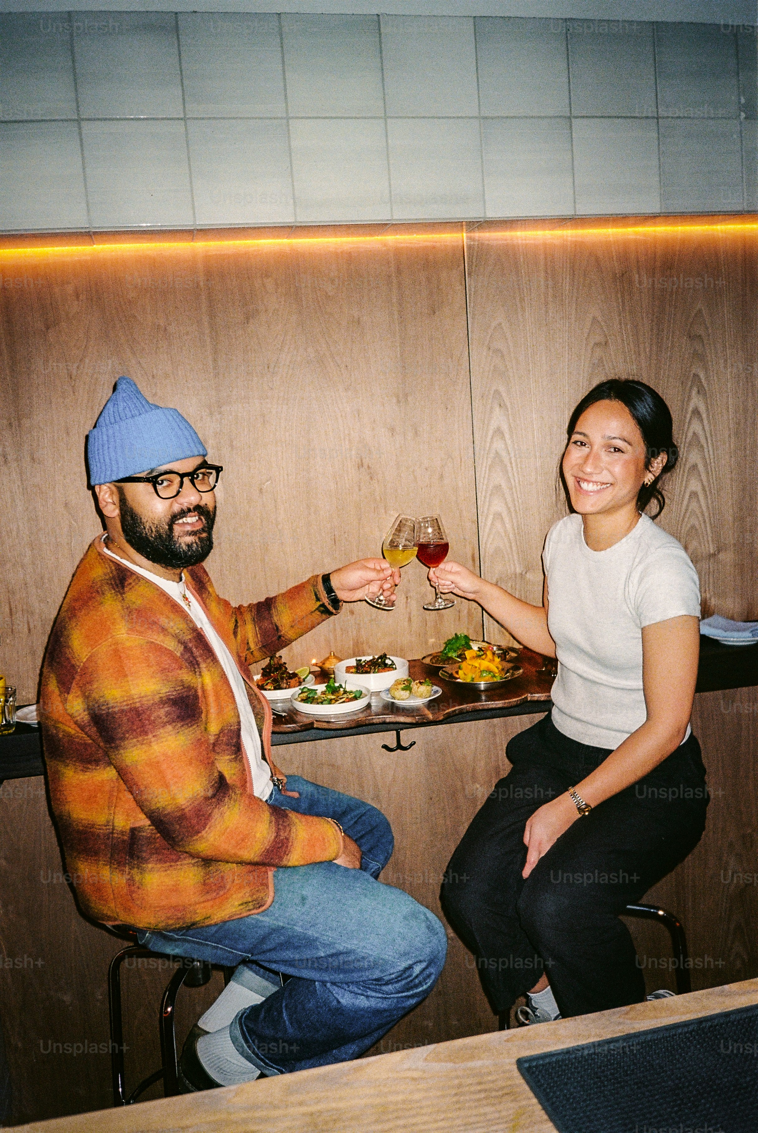 Couple toasting drinks at a restaurant table