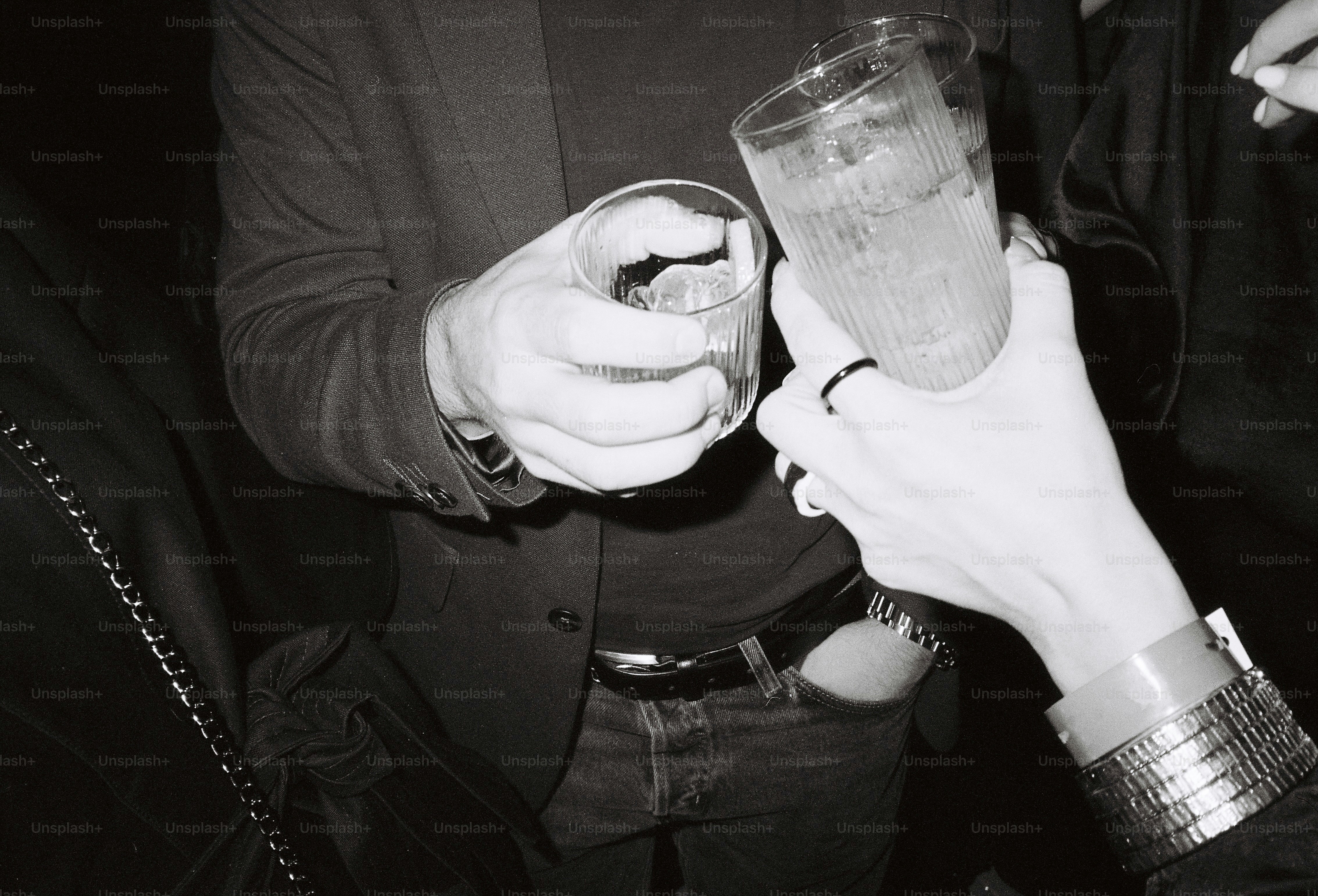 Two people clinking glasses with drinks